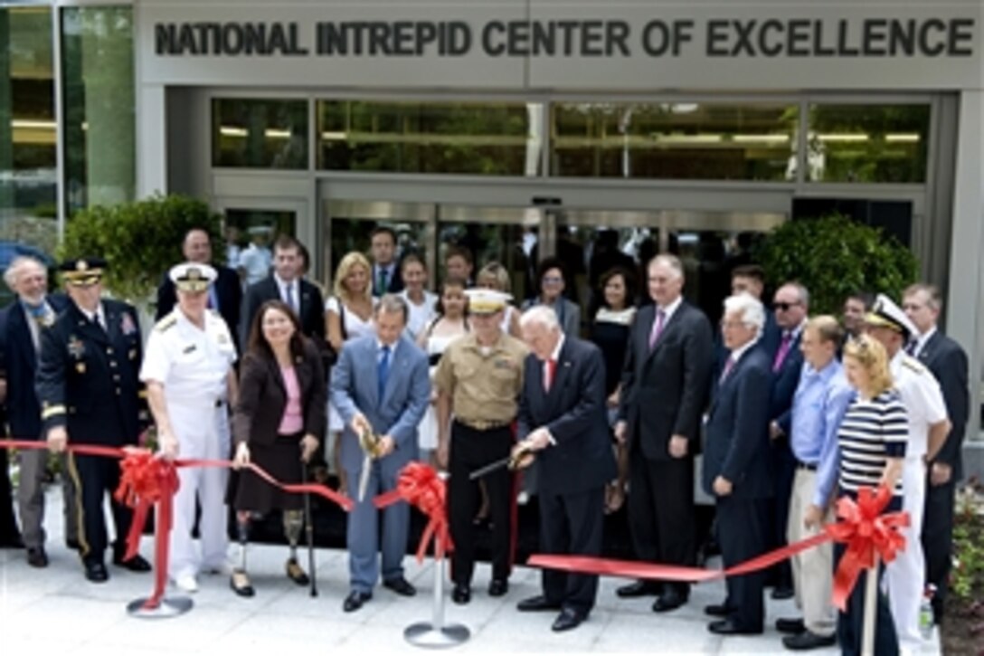 Richard Santulli, chairman of the Intrepid Fallen Heroes Fund, left, and Arnold Fisher, honorary chairman of the Intrepid Fallen Heroes Fund, right, cut the ribbon to officially open the National Intrepid Center of Excellence during a dedication ceremony at Bethesda National Naval Medical Center, Md., June 24, 2010. 