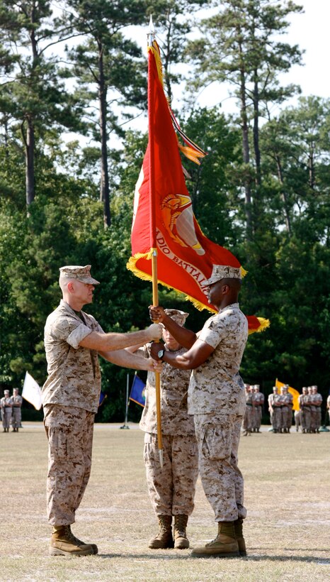Lt. Col. Jerry G. Carter (right), the outgoing commanding officer of 2nd Radio Battalion, II Marine Expeditionary Force Headquarters Group, passes the unit’s colors to Lt. Col. Matthew G. Rau, the incoming CO of 2nd Radio Bn., during a change of command ceremony June 24, 2010, aboard Marine Corps Base Camp Lejeune, N.C.