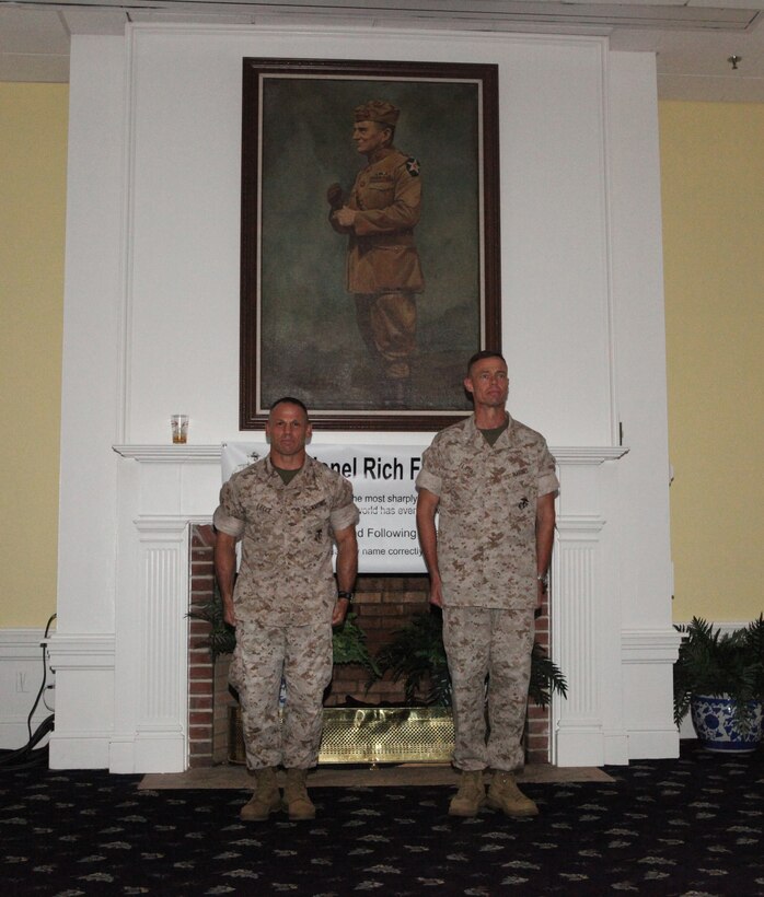 (from left to right) Col. Daniel J. Lecce, the new commanding officer of Marine Corps Base Camp Lejeune, stands next to outgoing commanding officer, Col. Richard P. Flatau Jr., during a change-of-command ceremony at Paradise Point Officers’ Club aboard the base, June 25.  Lecce and Flatau shook hands to signify the end of Flatau’s two-and-a-half year reign and the beginning of Lecce’s new role as commanding officer.