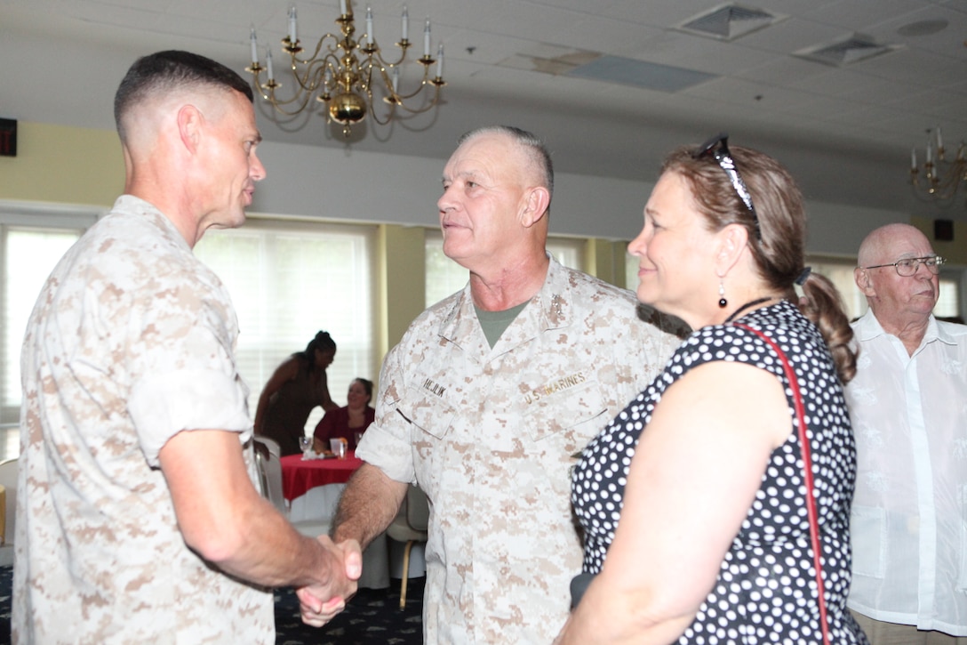 Lt. Gen. Dennis J. Hejlik (right), commanding general of II Marine Expeditionary Force, shakes hands with Col. Richard P. Flatau Jr., outgoing commanding officer of Marine Corps Base Camp Lejeune, after a change-of-command ceremony at Paradise Point Officers’ Club aboard the base, June 25.  Flatau is retiring from the Marine Corps after 27 years of active-duty service and is replaced by Col. Daniel J. Lecce, who most recently served as the staff judge advocate for 2nd Marine Aircraft Wing, Marine Corps Air Station Cherry Point.