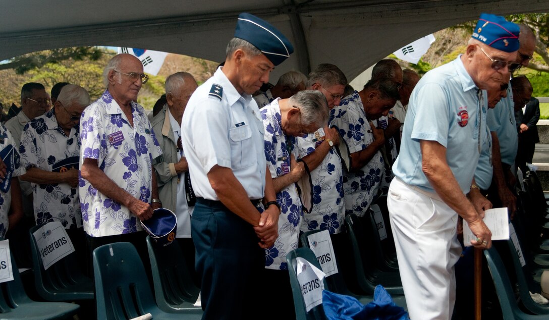 Korean War veterans and service members take a moment to honor the memories of those who fought and died in the Korean War during a Korean War Memorial Ceremony June 25 at the National Memorial Cemetery of the Pacific (Punchbowl), Hawaii. The Korean War began June 25, 1950.