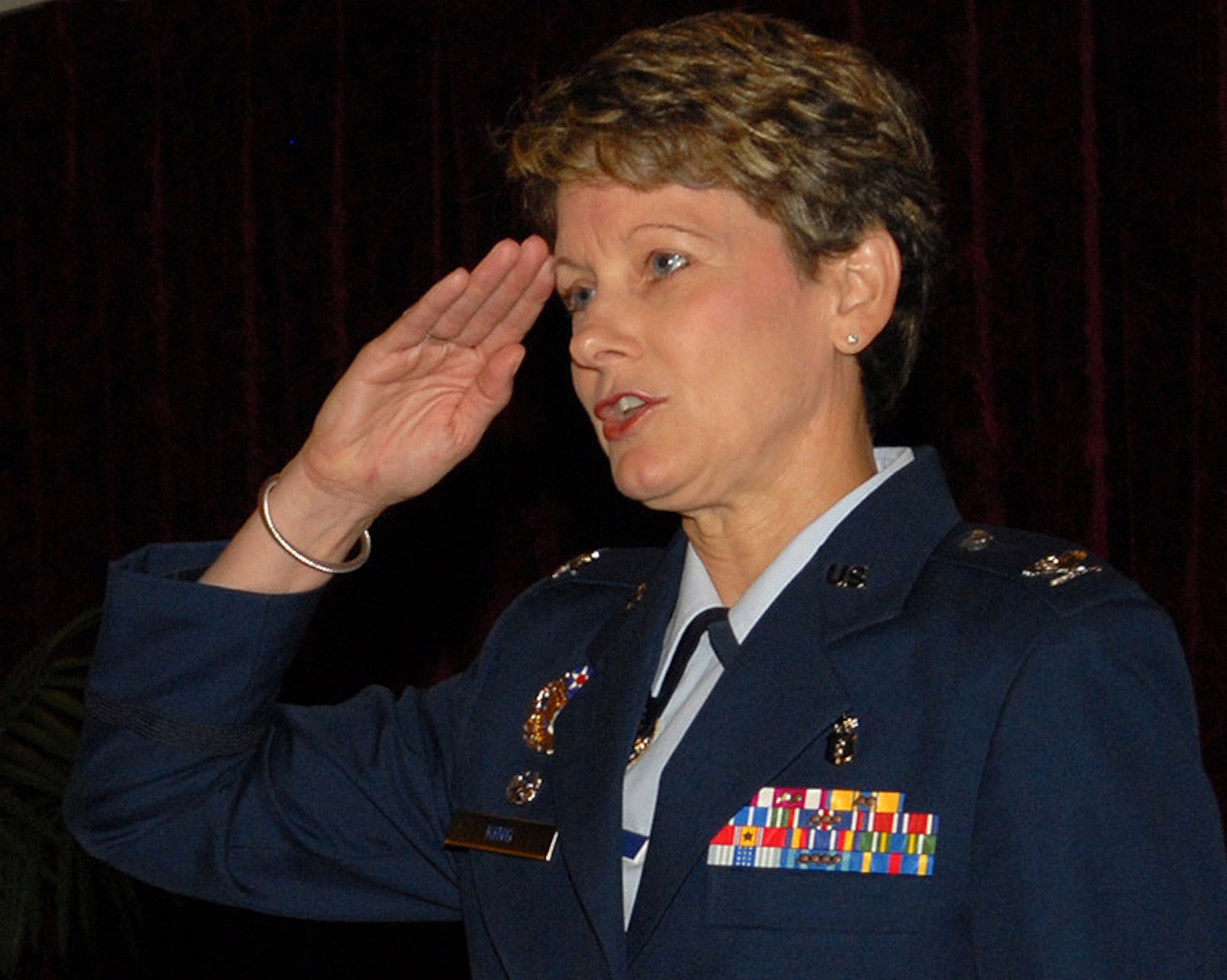 Col. Barbara King salutes her staff for the first time after taking command of the 18th Medical Group during a change of command ceremony at the Rocker NCO Club June 25. As the new group commander, Colonel King manages nearly 500 health care professionals who are tasked with providing care for more than 55,000 beneficiaries at the largest outpatient clinic in Pacific Air Forces. She is also charged with managing the second largest neonatal intensive care unit in the Air Force, a dental laboratory and the only aeromedical staging flight in the Western Pacific. (U.S. Air Force/Junko Kinjo)