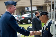 KUNSAN AIR BASE, Republic of Korea -- Col. John Dolan, 8th Fighter Wing commander, greets Sang Don Sin, Korean War Veterans Association Gunsan Chapter Vice Chairman, during the 60th anniversary of the Korean War commemoration ceremony held at the base flag pole. Fifty-one Korean War veterans including Vice Chairman Sin attended the ceremony, as well as Col. Jae Hun Choi, 38th Fighter Group commander. (U.S. Air Force photo/Staff Sgt. Jonathan Pomeroy)