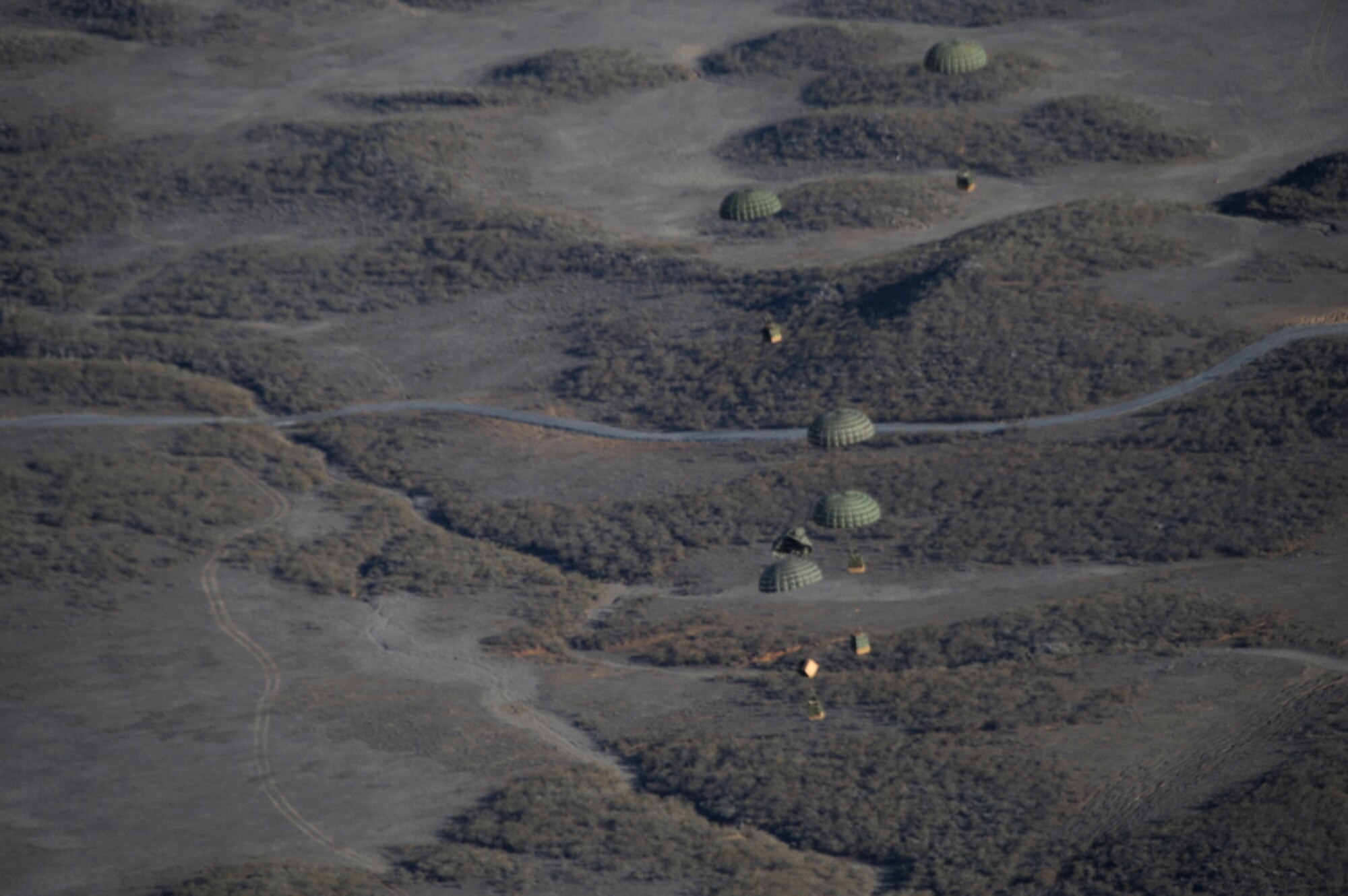 Joint Base Pearl Harbor-Hickam, Hawaii - Six Container Delivery system bundles comprised of Meals-Ready-To-Eat (MRE) and milk are descend to a designated drop zone area after being dropped from the ramps of a 535th Airlift Squadron C-17 Globemaster III while above the Big Island of Hawaii on June 24, 2010 in support of the Rim of the Pacific (RIMPAC) exercise. This is the 22nd year of RIMPAC, a biennial exercise that promotes interoperability of more than 14 partner nations as a key element of regional stability.  There are 14 nations, 32 ships, five submarines, more than 170 aircraft and 20,000 personnel participating in RIMPAC from June 23 through Aug. 1, in the Hawaiian operating area in, and around, the islands of Hawaii. (U.S.  Air Force photo/Tech Sgt. Cohen A. Young)