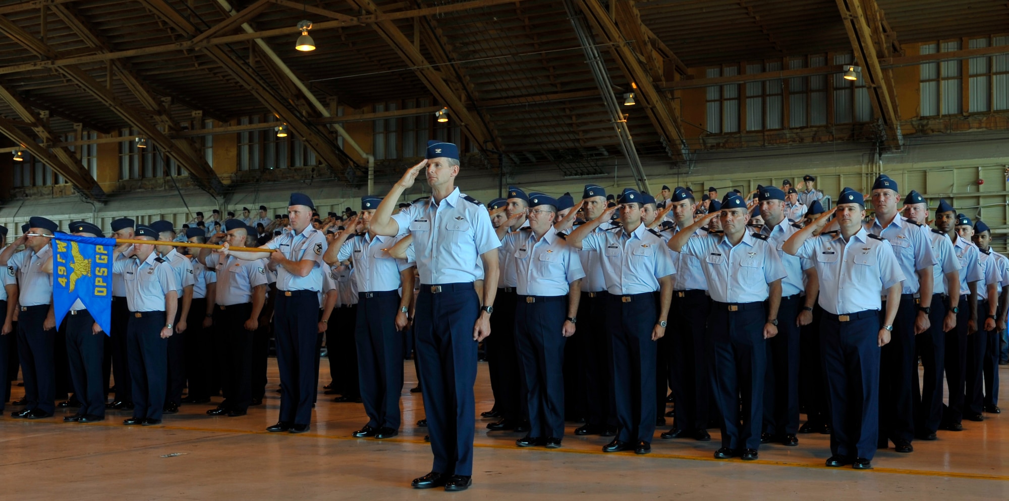 HOLLOMAN AIR FORCE BASE, N.M. -- Members of the 49th Operations Group give their final salute to Col. Jeff Harrigian, 49th Fighter Wing commander, during the 49th Wing Change of Command at hangar 301, June 25, 2010. Colonel Harrigian served as commander from January 2008 to June 2010. (U.S. Air Force photo by Airman 1st Class Joshua Turner / Released)