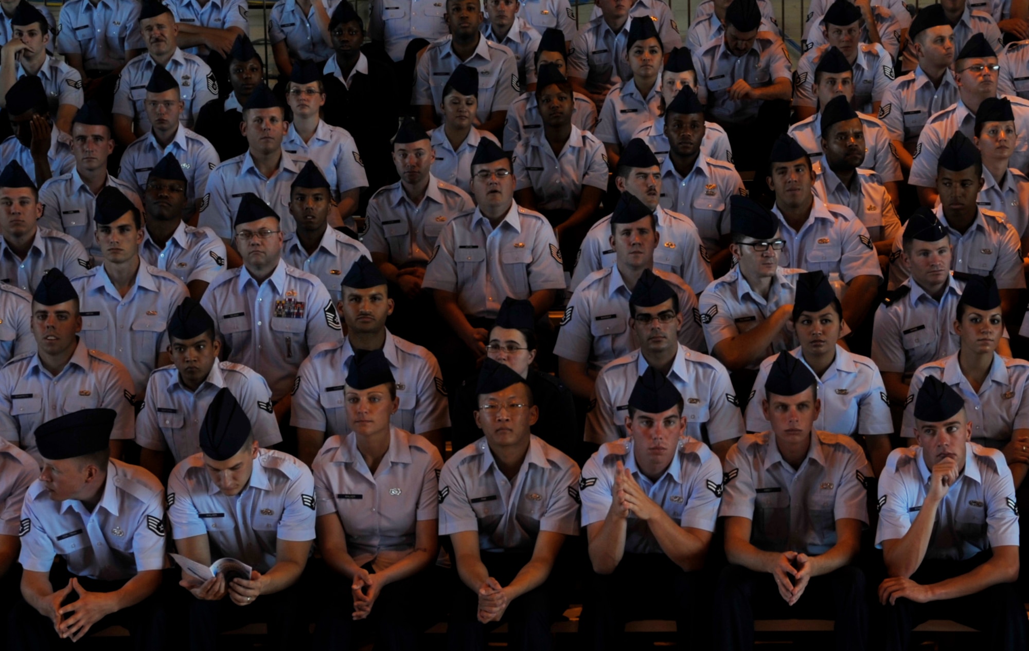 HOLLOMAN AIR FORCE BASE, N.M. -- Airmen of team Holloman listen during the 49th Wing Change of Command  at hangar 301, June 25, 2010. The 49th Fighter Wing guidon was cased by Lt. Gen Glenn Spears and the 49th Wing guidon was presented to Col. David Krumm. (U.S. Air Force photo by Airman 1st Class Joshua Turner / Released)