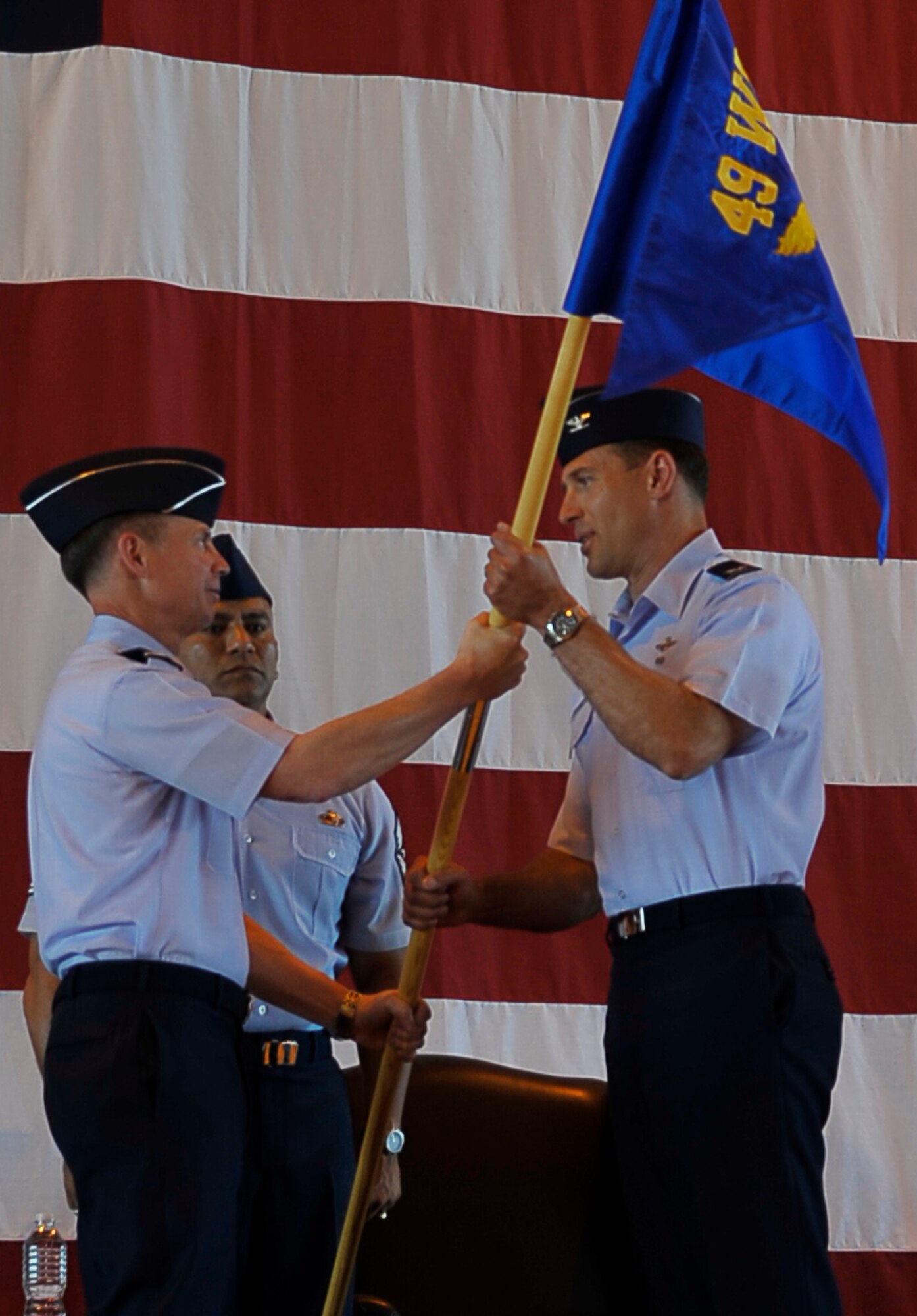 HOLLOMAN AIR FORCE BASE, N.M. -- Col. David Krumm accepts the newly designated  49th Wing guidon from Lt. Gen. Glenn Spears, 12th Air Force commander, during the 49th WG Change of Command at hangar 301, June 25, 2010. Colonel Krumm came to Holloman from the Pentagon where he served with Chief of Staff of the Air Force Fellowship Program. (U.S. Air Force photo by Airman 1st Class Joshua Turner / Released)