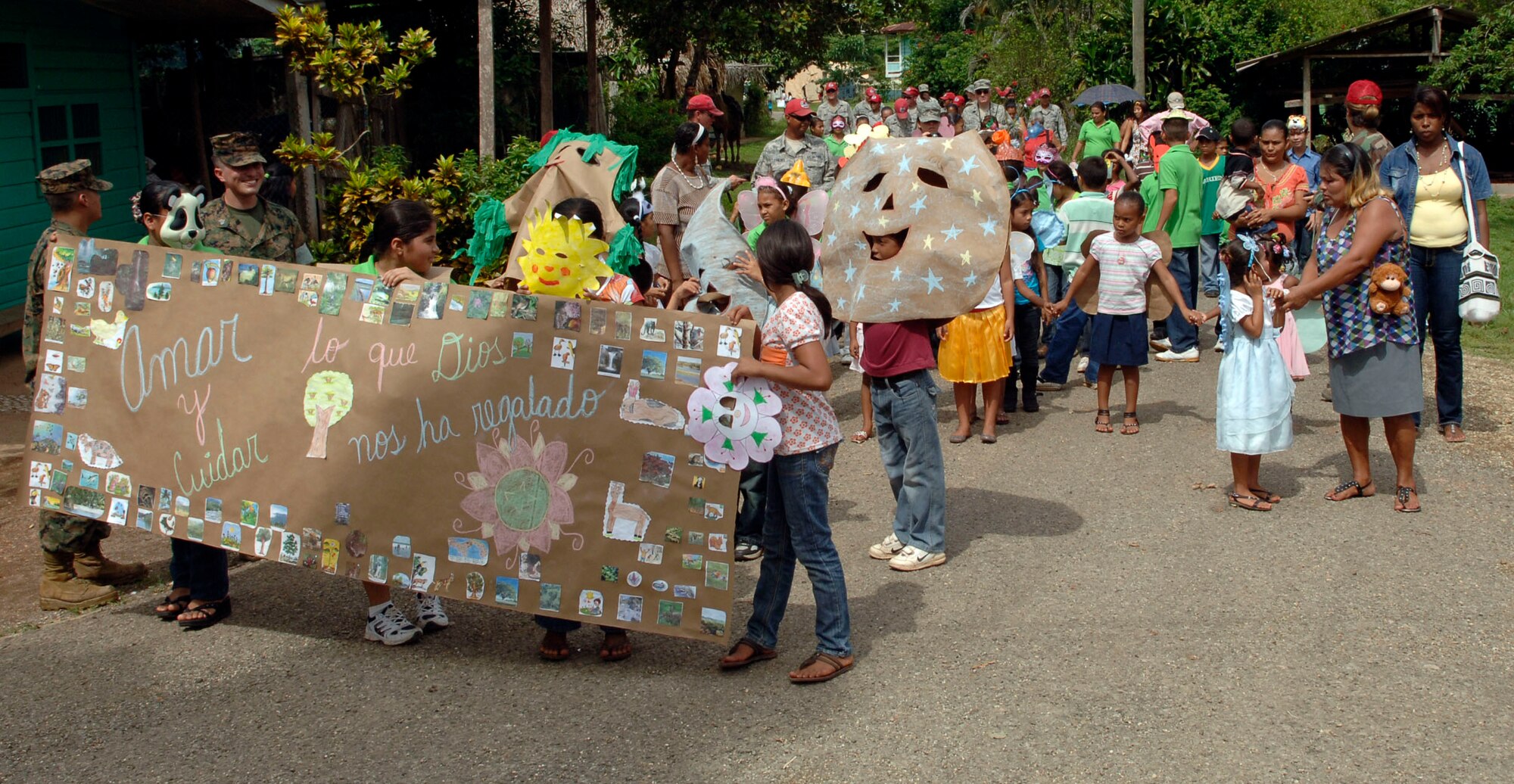 Children lead a parade of students, parents and U.S. service members in front of the Rio Iglesia elementary school June 24. Personnel from New Horizons Panama 2010 took time out of the construction schedule to support the school's conservation day festival. (U.S. Air Force photo/Tech. Sgt. Eric Petosky)