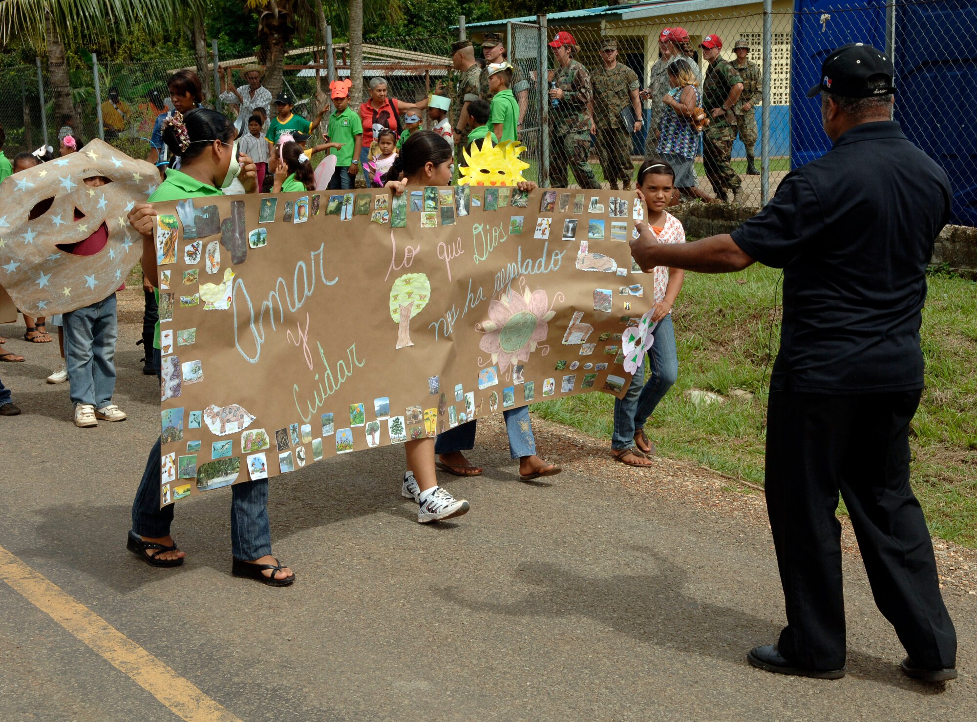 Children lead a parade of students, parents and U.S. service members in front of the Rio Iglesia elementary school June 24. Personnel from New Horizons Panama 2010 took time out of the construction schedule to support the school's conservation day festival. (U.S. Air Force photo/Tech. Sgt. Eric Petosky)