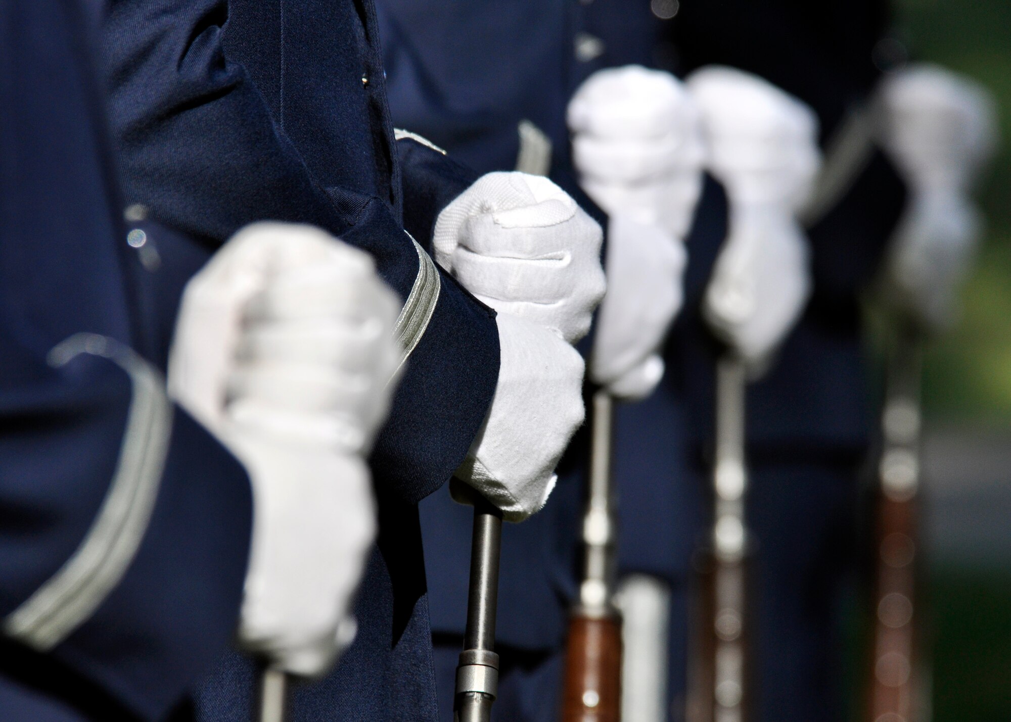 Members of the 96th Air Base Wing honor guard rifle team stand at the ready prior to the ceremony, that marked the 14th anniversary of the Khobar Towers tragedy, at the memorial on Eglin Air Force Base, Fla., June 25.  Almost 100 friends, family and current members of the 33rd Fighter Wing gathered for a remembrance ceremony near the memorial dedicated to the heroism of 12 Airmen lost. The 33rd FW suffered 105 wounded personnel and accounted for 12 of the 19 Airmen killed in the Khobar Towers terrorist attack June 25, 1996. (U.S. Air Force Photo/ Samuel King Jr.) 