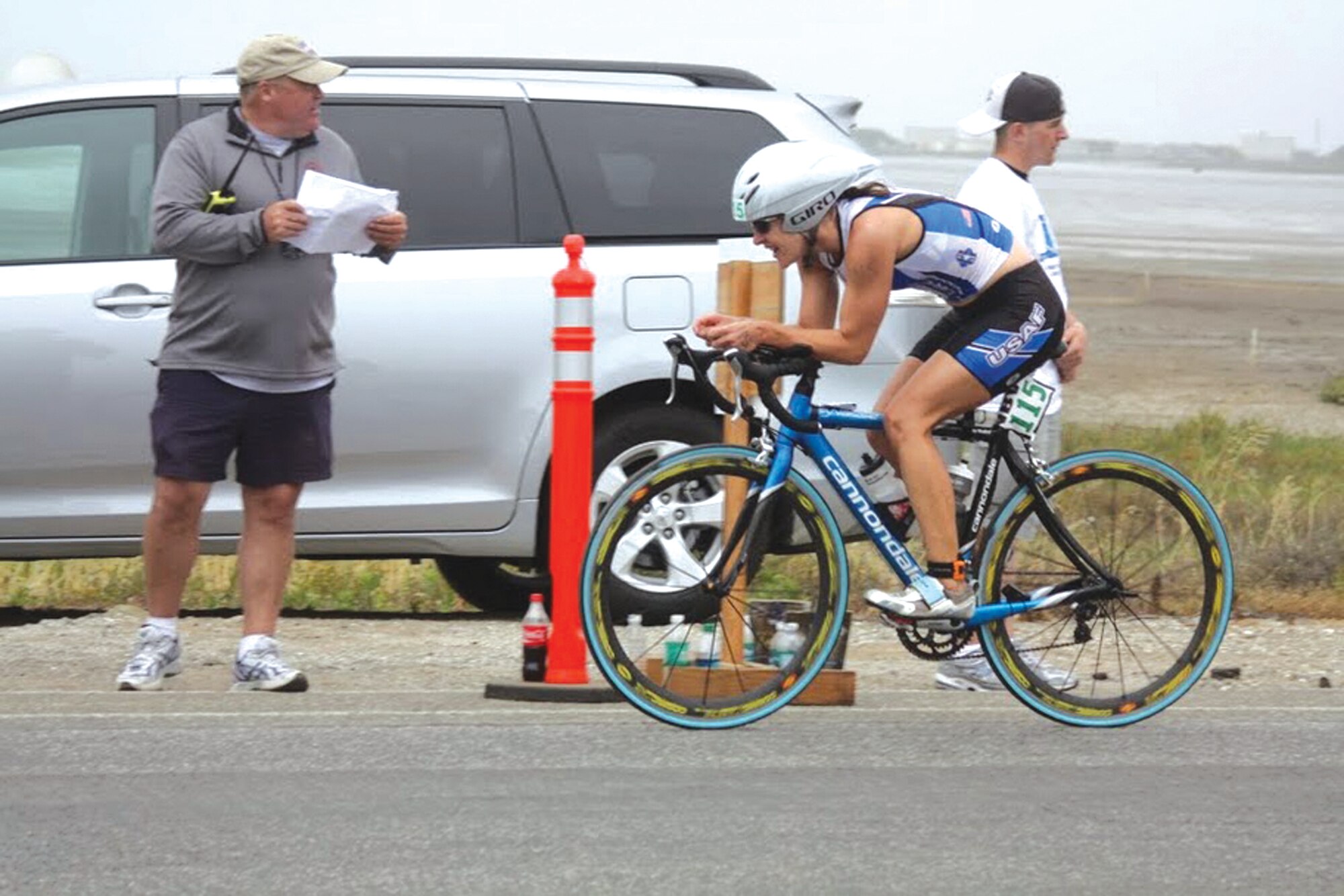 First Lt. Kathy Rakel, 56th Operations Support Squadron chief of intel readiness, bikes past a check point during the Armed Forces Triathlon Championship. She completed the triathlon in 2 hours and 4 seconds becoming the first woman from the Air Force to win the gold. The Air Force Triatholon team was the first team ever to win gold in the male, female and team categories. (courtesy photo)