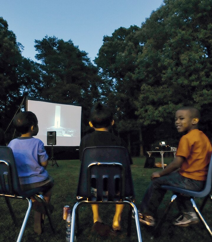 JOINT BASE ANDREWS, Md. --  A group of Andrews Youth Center children are treated to a free viewing of the animated film, ‘Astro Boy,’ outside on the playground, during Family Movie Night at the Youth Center June 18. Movies are shown the third Friday of every month. (U.S. Air Force photo by Bobby Jones)