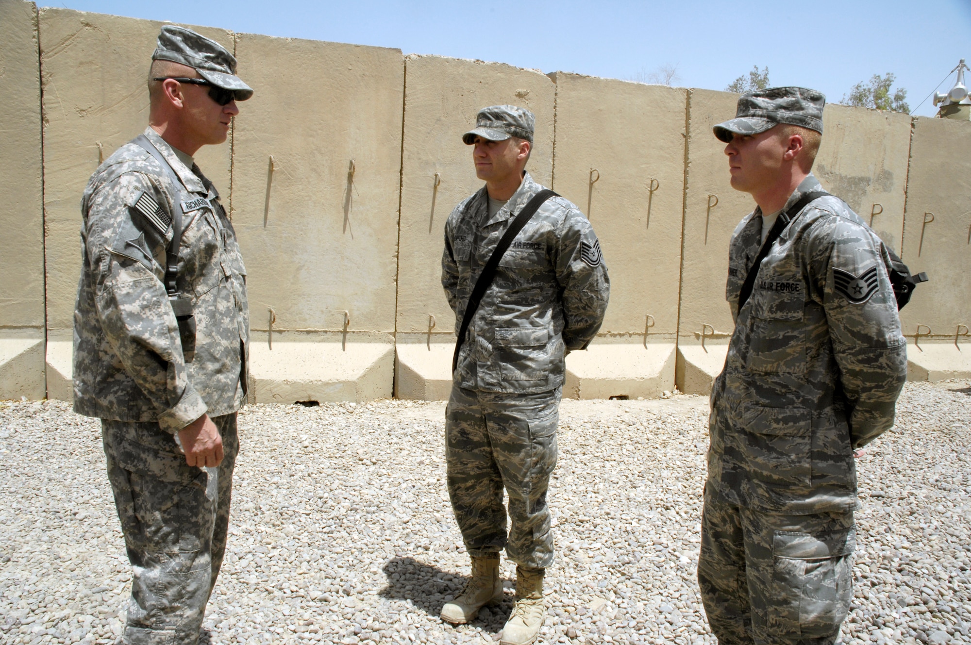 Army Sgt. Maj. Jerry Richardson (left) present coins recently on behalf of Army Brig. Gen. Gustave Perna and himself to Tech. Sgt. Aaron Gufford (center) and Staff Sgt. Jeffery Kirker (right) to say thanks for their quick reactions in saving Lt. Col. Mitchell Malone's life June 7, 2010, outside the Liberty Gym at Camp Liberty, Iraq. The presentation of a coin to someone who has done an outstanding job is a time-honored military tradition observed by all branches of the military. General Perna is the U.S. Air Force-Iraq J4 director. Sergeant Richardson is from U.S. Air Force-Iraq at Camp Liberty. Sergeants Gufford and Kirker are both of the 392nd Expeditionary Signal Battalion at Camp Liberty. (U.S. Air Force photo/Staff Sgt. Sanjay Allen)