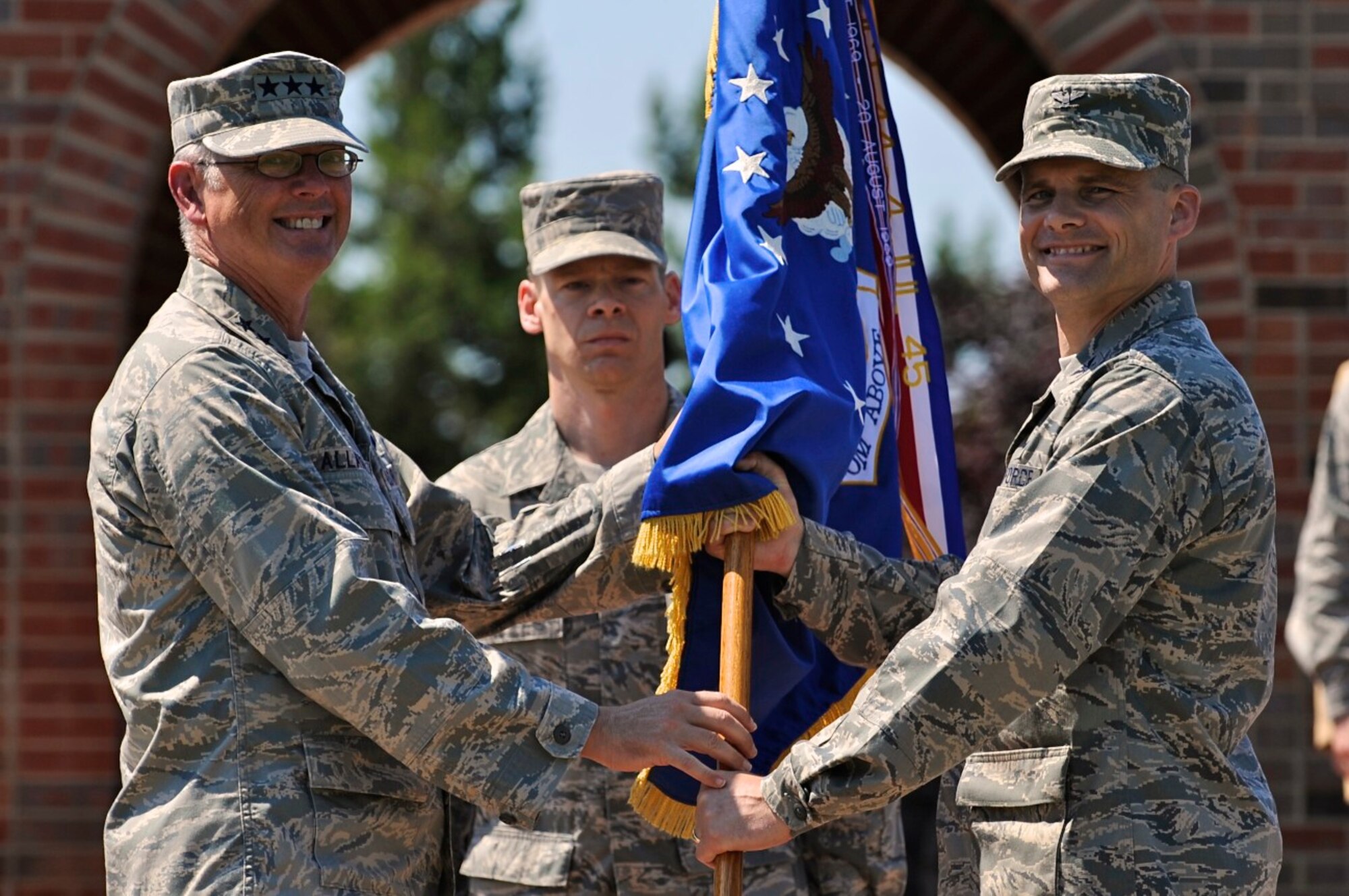 SCOTT AIR FORCE BASE, Ill. -- Left, Lt. Gen. Robert Allardice, 18th Air Force commander, passes the 375th Air Mobility Wing flag to Col. Michael Hornitschek as he assumes command Friday. Colonel Hornitschek arrives from McChord Air Force Base, Wash., where he served as the vice commander. (U.S. Air Force photo/ Senior Airman Ryan Crane)