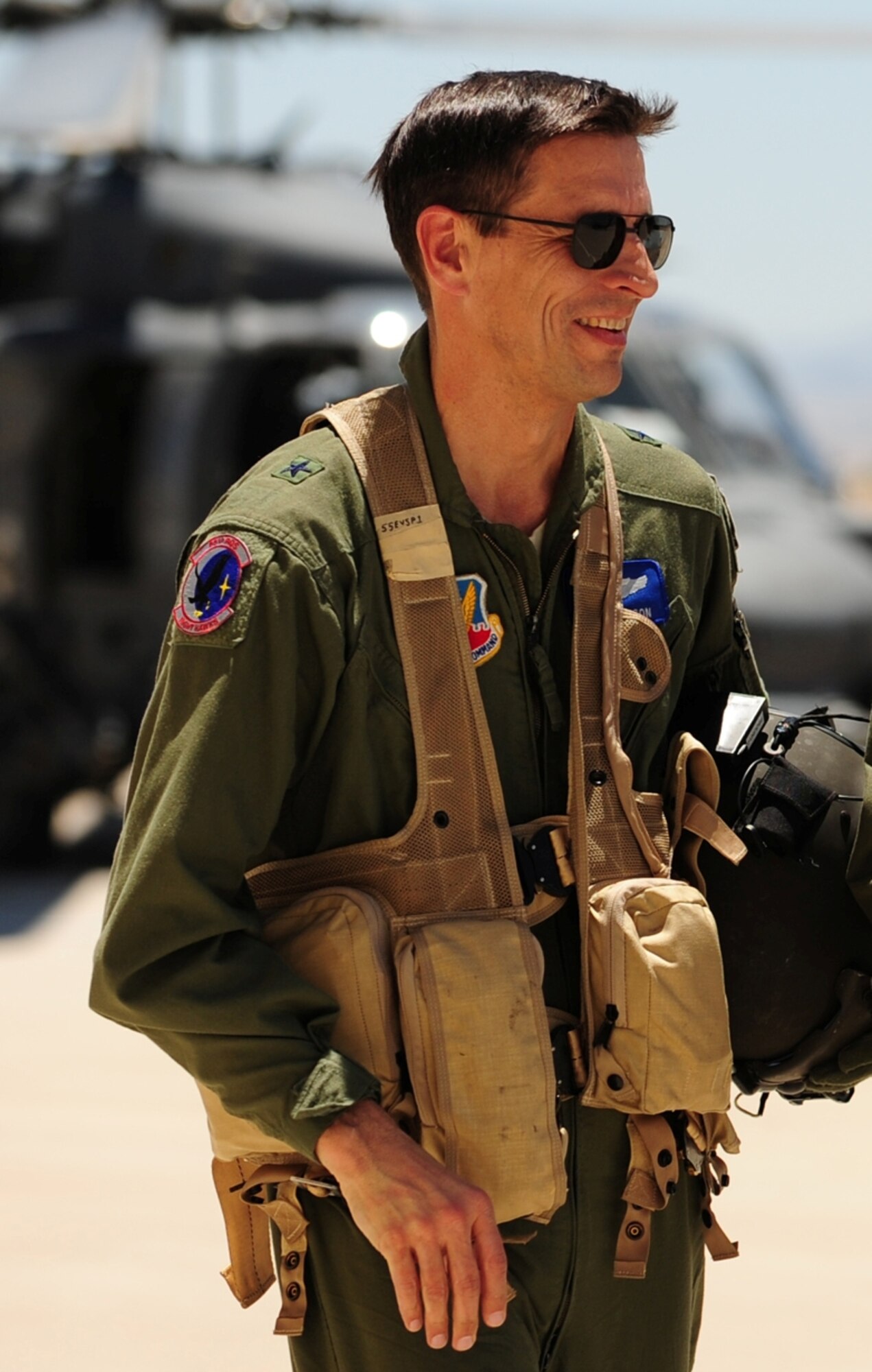 Brig. Gen. Paul T. Johnson, commander of the 355th Fighter Wing, smiles after an orientation flight June 4, 2010, in an HH60-G Pave Hawk. General Johnson, who's scheduled to relinquish command here June 28, will soon be on his way to Afghanistan to command the 451st Air Expeditionary Wing at Kandahar Airfield. Among several other combat assets, the 451st includes the largest HH-60 personnel recovery unit within all of Operation Enduring Freedom. (U.S. Air Force photo/Airman 1st Class Jerilyn Quintanilla)