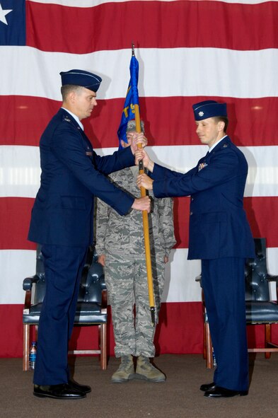LAUGHLIN AIR FORCE BASE, Texas – Lt Col. Michael N. Mathes, new 84th Flying Training Squadron commander, receives the 84th FTS guidon from Col. Craig Wills, 47th Operations Group commander, during the squadron’s change-of-command ceremony here Jun 25. Colonel Mathes recently completed the T-6A Texan II Pilot instructor training. He is a command pilot with over 2500 hours, including 900 instructor hours, and 460 combat hours. (U.S. Air Force photo by Jose Mendoza)