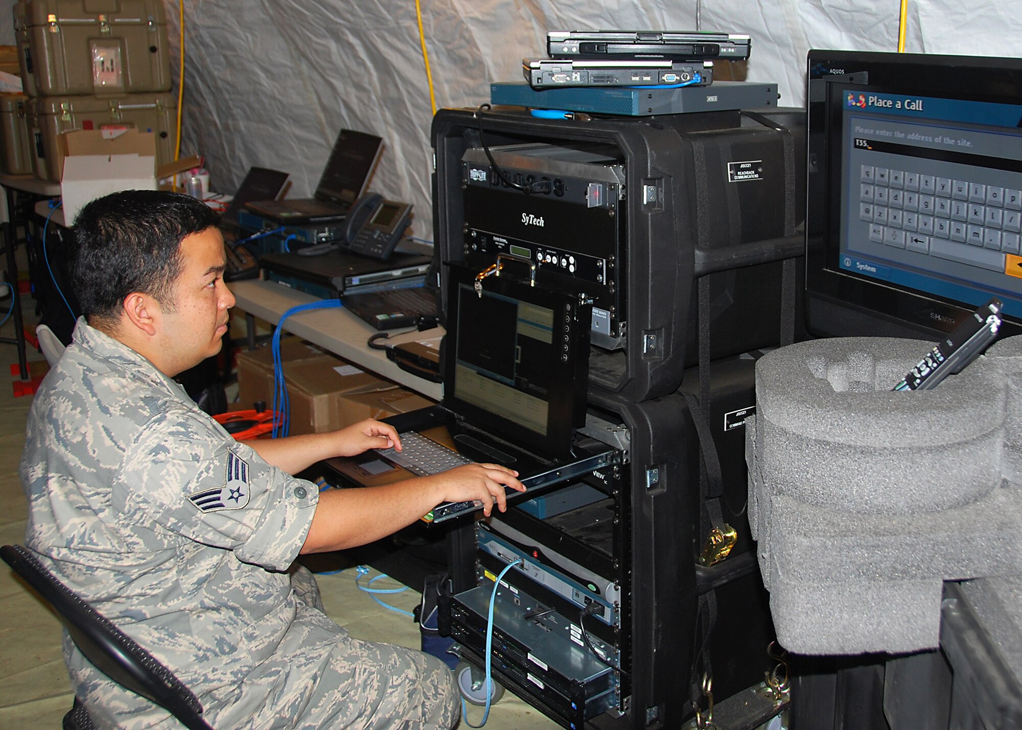 JOINT BASE MCGUIRE-DIX LAKEHURST, N.J. -- Senior Airman Sigmund Tanseco, 42nd Combat Communications Squadron, operates communications equipment during a training exercise here June 23, 2010. The Joint Users Interoperability Communications Exercise, commonly referred to as JUICE, is an annual exercise that focuses on integrating cutting-edge communications technologies into military and emergency-response operations. (U.S. Air Force photo/Staff Sgt. Shawn J. Jones)