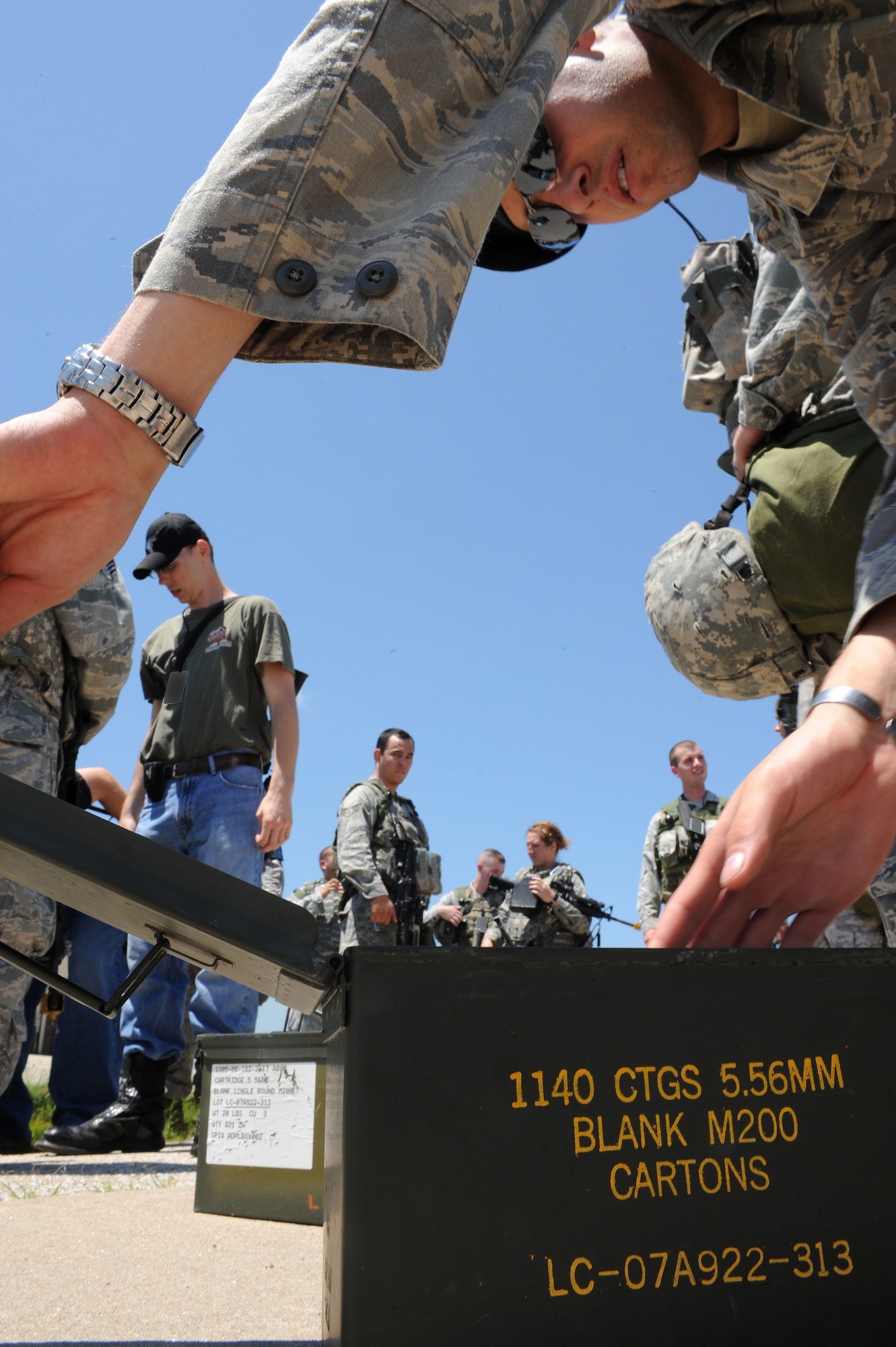 WHITEMAN AIR FORCE BASE, Mo. - Airmen from 509th Security Forces Squadron gather expended blank shell casings following a force-on-force exercise June 18. The 509th SFS Airmen cleaned up and then gathered to discuss the exercise. (U.S. Air Force photo by Tech. Sgt. Charles D. Larkin Sr.)