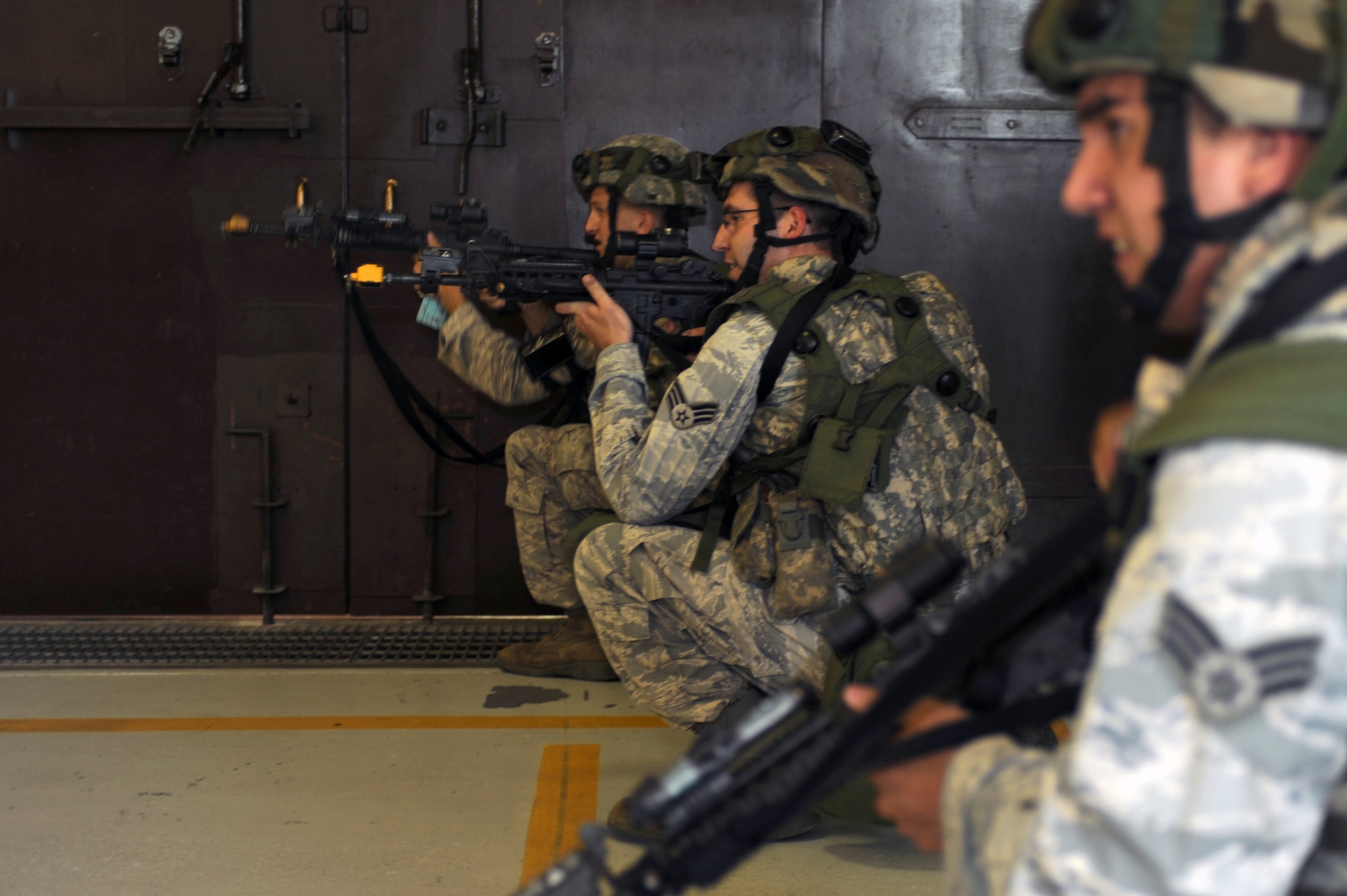 WHITEMAN AIR FORCE BASE, Mo. - Airmen from the 509th Security Forces Squadron fire blanks at simulated attackers during a force-on-force exercise June 18. The Airmen cleared the building of simulated attackers using blank rounds to produce a realistic atmosphere for the exercise. (U.S. Air Force photo by Tech. Sgt. Charles D. Larkin Sr.)