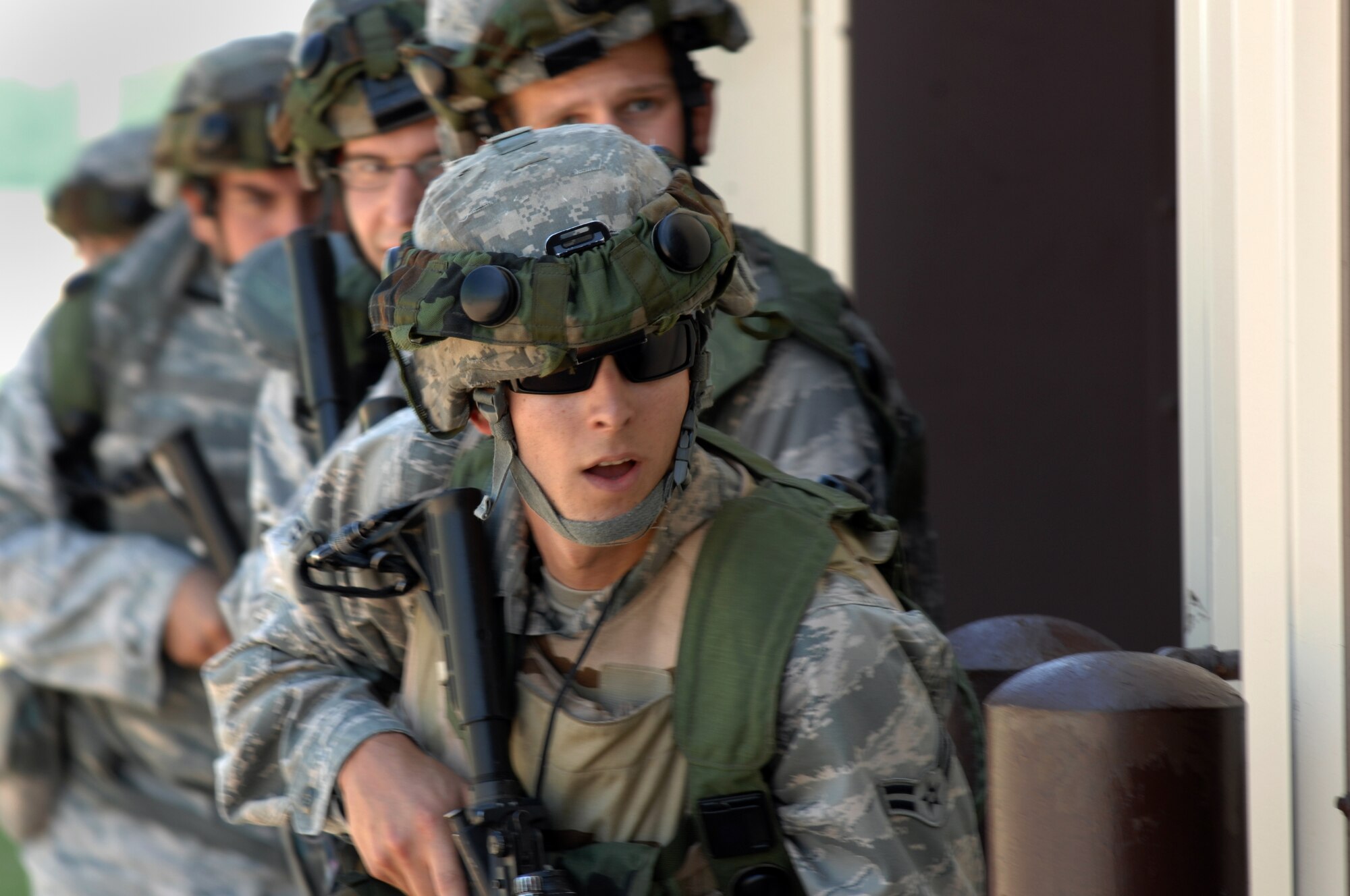 WHITEMAN AIR FORCE BASE, Mo. - Airmen from the 509th Security Forces Squadron form-up as an entry team during a force-on-force exercise June 18. The Airmen simultaneously filed into the building in attempt to recapture the building for the exercise. (U.S. Air Force photo by Tech. Sgt. Charles D. Larkin Sr.)