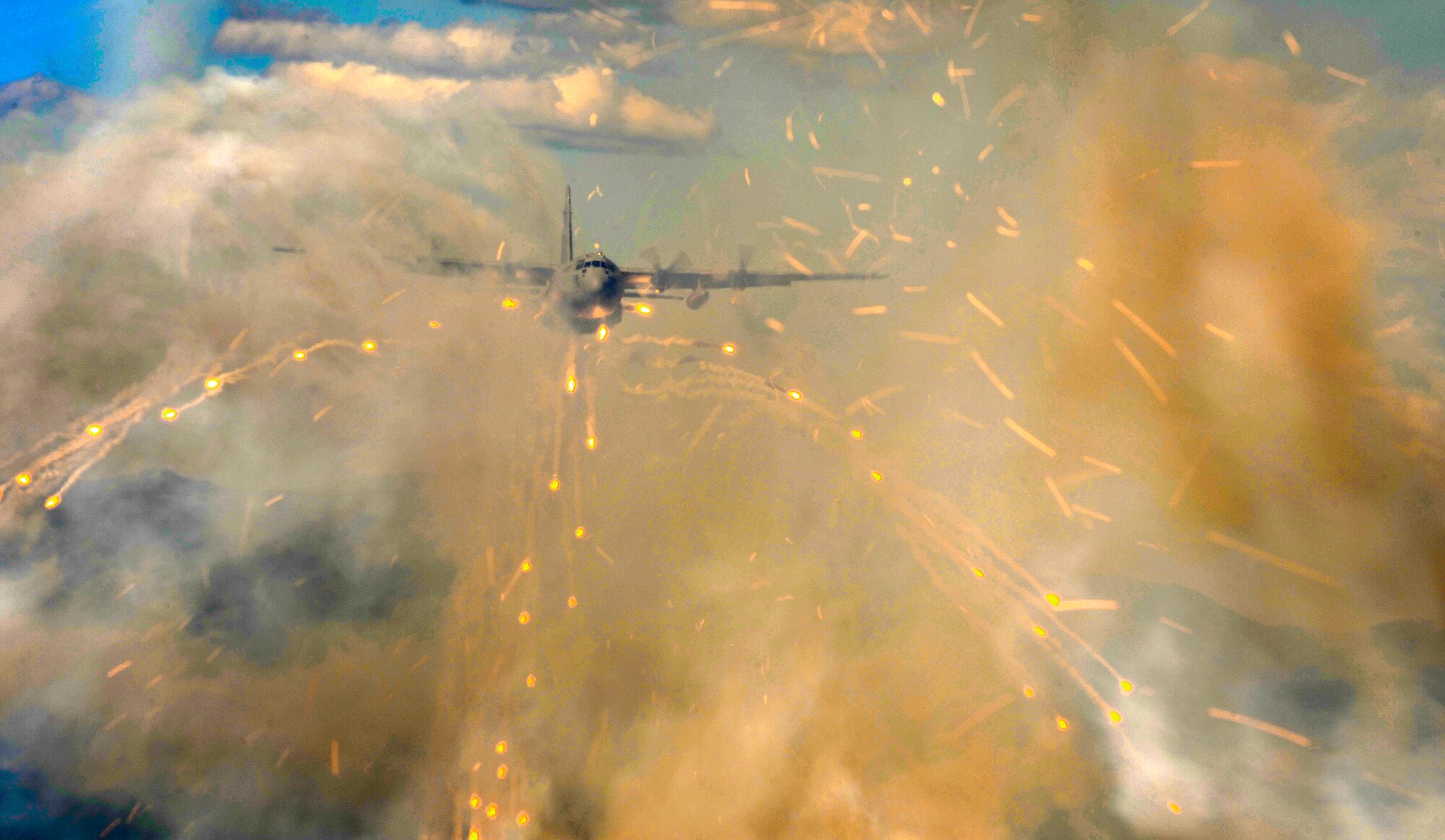 A 36th Airlift Squadron C-130H Hercules from Yokota Air Base, Japan, deploys flares over Alaska as part of a training exercise during Red Flag Alaska 10-3, June 23. (U.S. Air Force photo/Staff Sgt. Brian Ferguson)