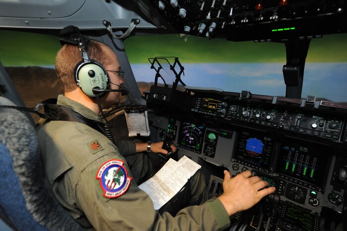 U.S. Air Force Maj. Brian Nicosia conducts training in the C-17 simulator on Joint Base Charleston, S.C., June 21, 2010. Major Nicosia is the chief of tactics with the Heavy Airlift Wing at Papa Air Base, Hungary, and is visiting JB CHS for quarterly pilot training. The Heavy Airlift Wing stood up approximately one year ago, and Major Nicosia fills a unique position as a U.S. C-17 pilot assigned to the unit. There are currently three C-17 aircraft assigned to the Heavy Airlift Wing. (U.S. Air Force photo/James M. Bowman)(Released)