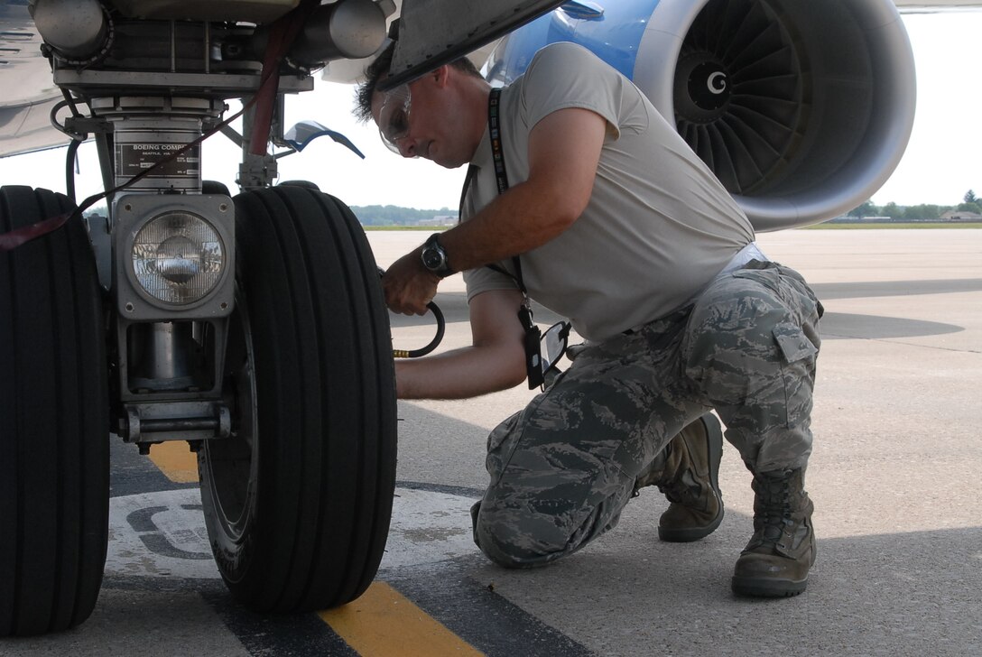 Scott AFB, IL--Tech. Sgt. Rick Bommarito of the 932nd Maintenance Squadron checks air pressure on the C-40C's tires on the flightline.   The C-40C is flown by the 932nd Airlift Wing an Air Force Reserve unit based here.  (U.S. Air Force photo/Tech. Sgt Dan Oliver)  
