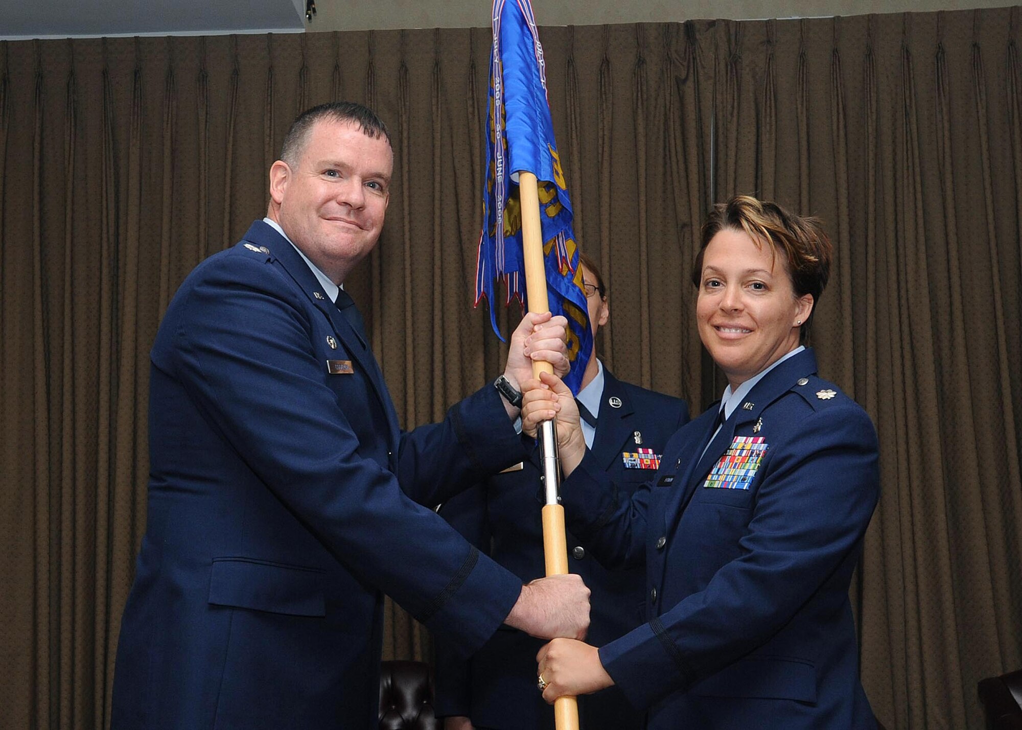 Lt. Col. Leah J. Erwin, (right) assumes command of the 319th Medical Support Squadron from Lt. Col. David Cockrum, 319th Medical Operations Squadron commander, during a change-of-command ceremony, June 25 at Grand Forks Air Force Base, North Dakota. Col. Erwin assumed command of the 319 MDSS from Lt. Col. Larsen. (U.S. Air Force photo by Tech. Sgt. Johnny Saldivar)