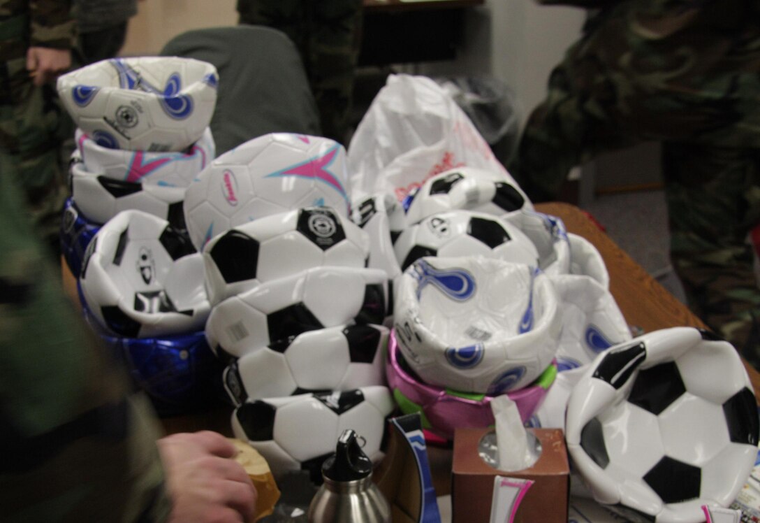 Members of the 566th deflate soccer balls before packing them to ship to children in Iraq.  This was coordinated with MSgt William Swanberg, our 1st Sgt, while he was deployed to Kirkuk, Iraq serving as a 1st Sgt for the base there.  This photo was taken by SSgt Peggy Miller in February 2010.
