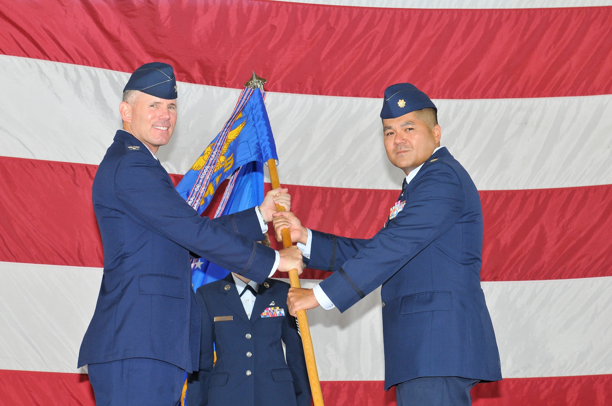 Major Christopher Cullen accepts the 325th Maintenance Operations Squadron guidon from Col. Craig Hall, 325th Maintenance Group commander, during a Change of Command ceremony June 25 at Tyndall Air Force Base.  Major Cullen replaces Maj. Richard Flamand as the new 325th MOS commander.  Major Cullen comes to Tyndall from the Secretary of the Air Force International Affairs Military Personnel Exchange Program, Washington, D.C. (U.S. Air Force photo by Lisa Norman)