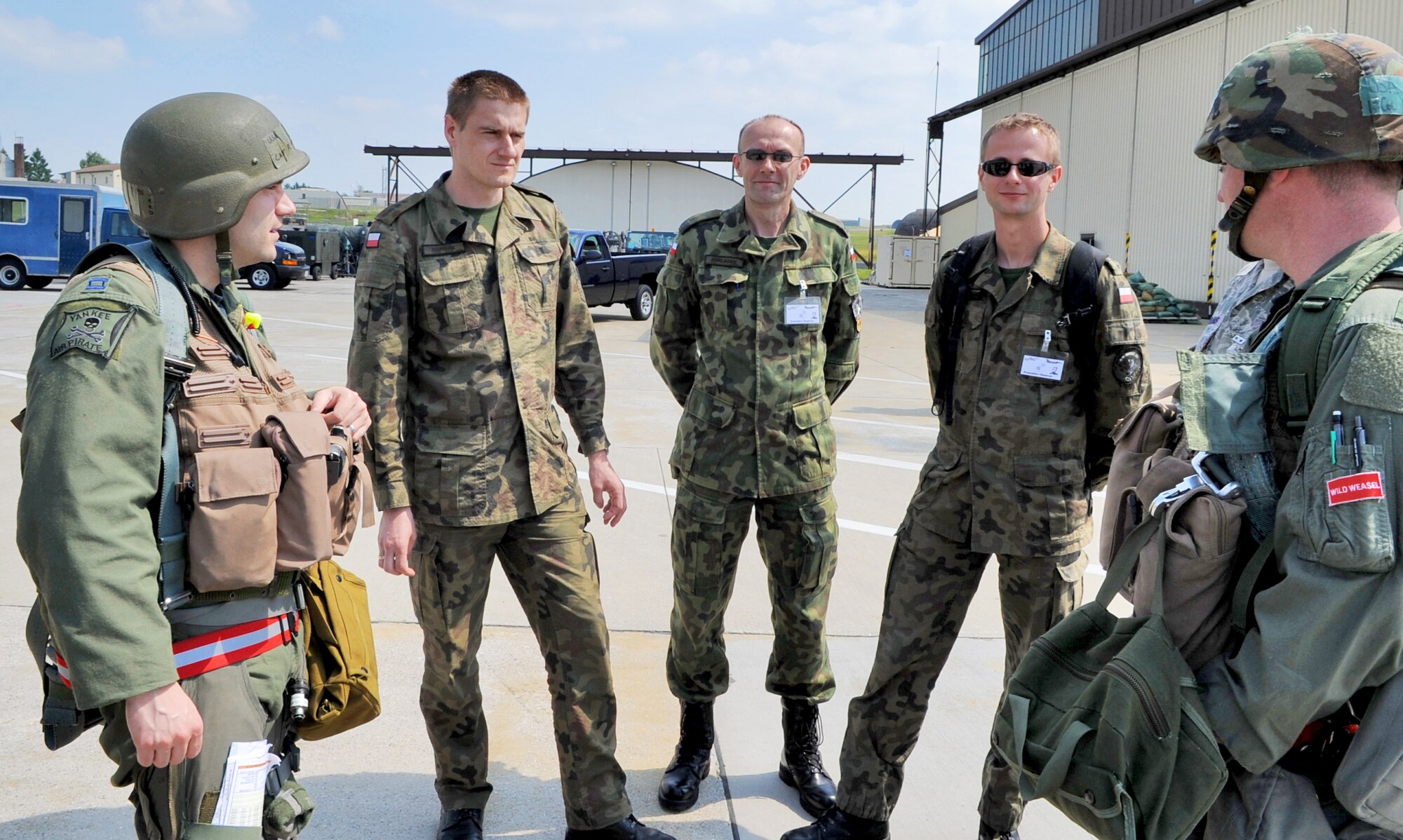 SPANGDAHLEM AIR BASE, Germany – Clockwise from the right, pilots from the 22nd Fighter Squadron, Lt. Col. Paul Murray and Capt. Robert  Sandwith, meet Polish air force members from the 32nd Air Tactical Base, Poland, Capt. Chris Marciak, Maj. Andriej Pokladek and Lt. Mariusz Choszczewski during a U.S. Air Forces in Europe Operational Readiness Inspection here June 23. Members from headquarters USAFE and Aviano Air Base’s 31st Fighter Wing escorted their Polish counterparts during the USAFE ORI. The Polish Air Force’s 32nd Tactical Air Base, which includes F-16 Fighting Falcons, will have its first ever practice NATO tactical evaluation in August. (U.S. Air Force photo/Airman 1st Class Nick Wilson)