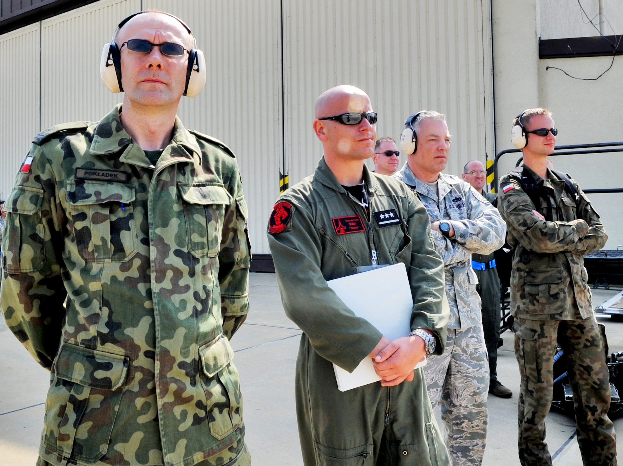 SPANGDAHLEM AIR BASE, Germany – From left to right, Polish air force members from the Air Tactical Base, Poland; Maj. Andriej Pokladek, Lt. Dominik Duda; Master Sgt. Jason Williams, readiness superintendent, 31st Maintenance Group, Aviano Air Base, Italy; and Lt. Mariusz Choszczewski, 32nd Air Tactical Base, Poland, observe as Airmen from the 52nd Aircraft Maintenance Squadron perform maintenance on F-16 Fighting Falcons during a U.S. Air Forces in Europe Operational Readiness Inspection here June 23. Members from headquarters USAFE and Aviano Air Base’s 31st Fighter Wing escorted their Polish counterparts during the USAFE ORI. The Polish Air Force’s 32nd Tactical Air Base, which includes F-16 Fighting Falcons, will have its first practice NATO tactical evaluation in August. (U.S. Air Force photo/Airman 1st Class Nick Wilson)