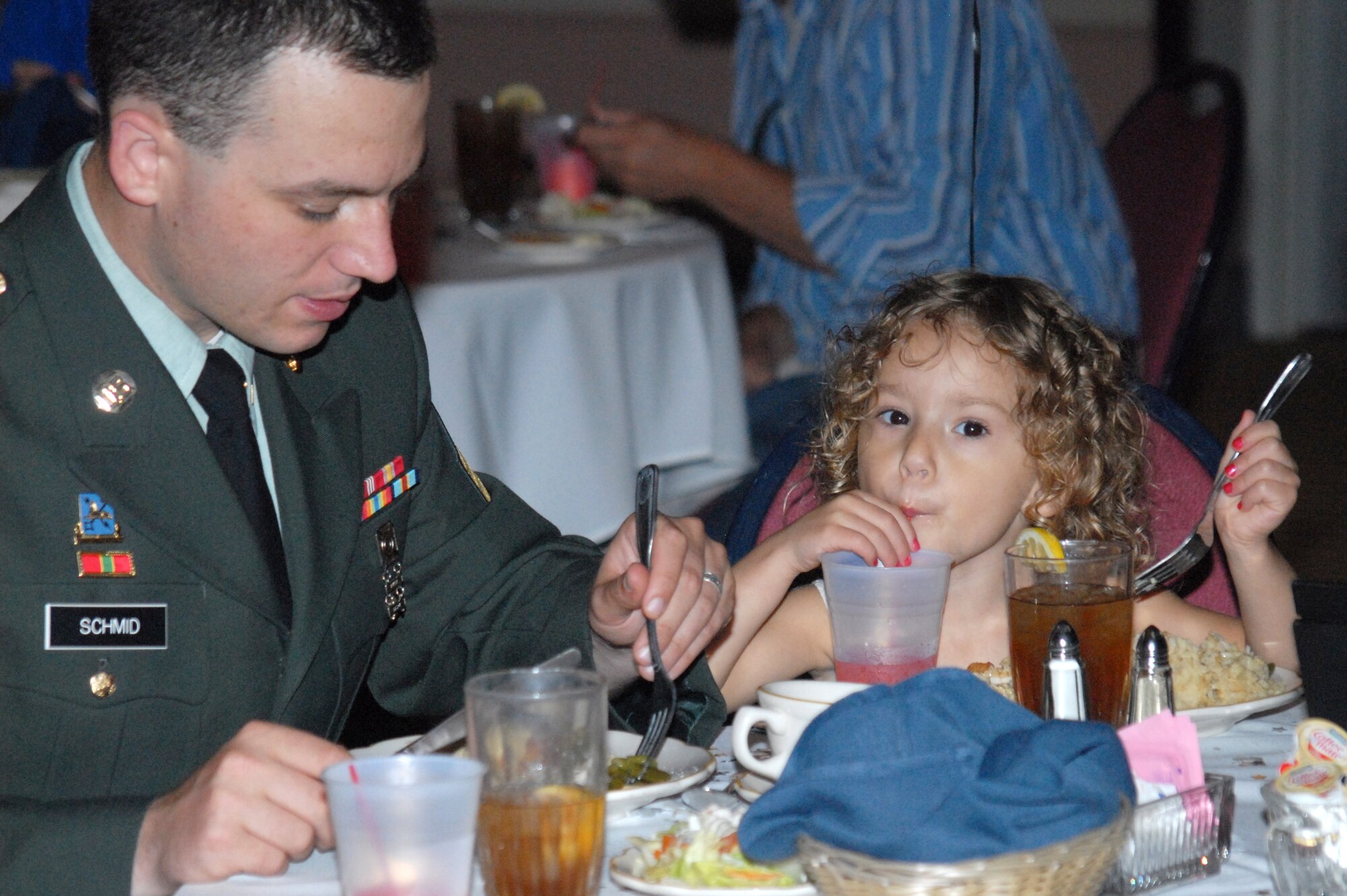 Army Sgt. Tony Schmid, 344th Military Intelligence Battalion, and his daughter Hailey, 3, dine on their star-studded meal served at the Sixth Annual Daddy/Daughter Dinner Dance June 24 at the Event Center. More than 20 dads and daughters took part in this year's Hollywood-themed event. (U.S. Air Force photo/Connie Hempel)