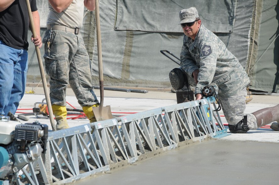 Senior Master Sgt. Rodney Draeger, of the 119th Civil Engineer Squadron, operates a power screed, which is used to level out freshly poured concrete, June 24, at the North Dakota Air National Guard, Fargo, N.D. The concrete is being used for a foundation for a regional training site facility and is one of many construction and remodeling projects under way at the Fargo Air National Guard base.