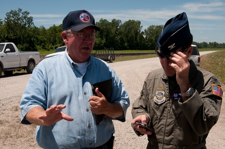 139th Airlift Wing Commander, Col. Mike McEnulty, speaks to a local emergency manager during flood prevention efforts at Bean Lake, Mo., June 24, 2006. After weeks of heavy rains, Governor Jay Nixon declares a state of emergency on June 21, with the 139th Airlift Wing in St. Joseph Mo., taking command in North West Missouri for the National Guard.  (U.S. Air Force photo by Master Sgt. Shannon Bond/Released)