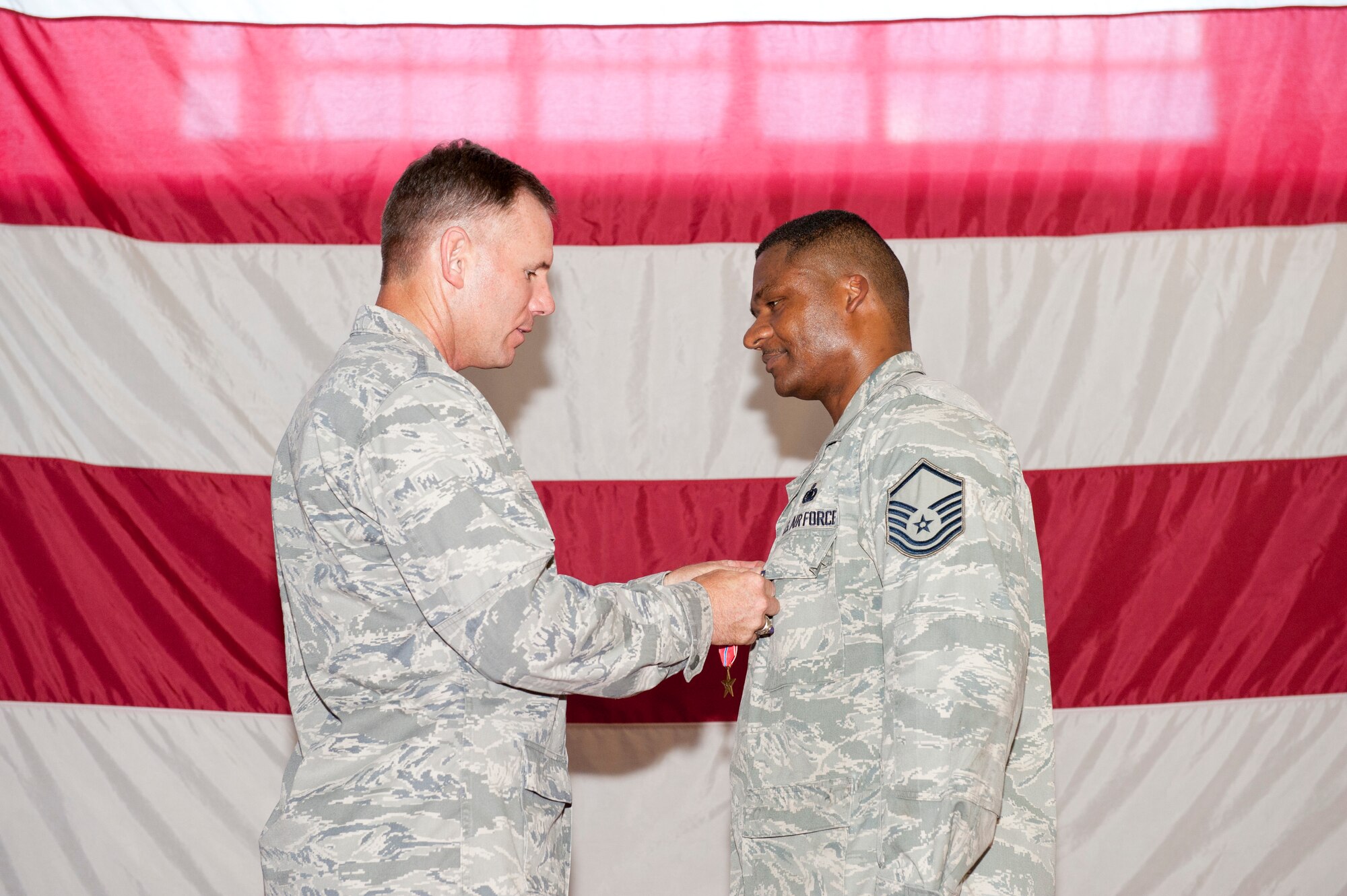 Colonel Craig Hall, 325th Maintenance Group commander, pins the Bronze Star medal on Master Sgt. Kory Duarte, 325th Aircraft Maintenance Squadron supply section chief during a ceremony June 23.  Sergeant Duarte earned the medal for his actions while deployed to Afghanistan in support of Operation Enduring Freedom from May 2009 to May 2010. (U.S. Air Force photo by Jonathan Gibson)