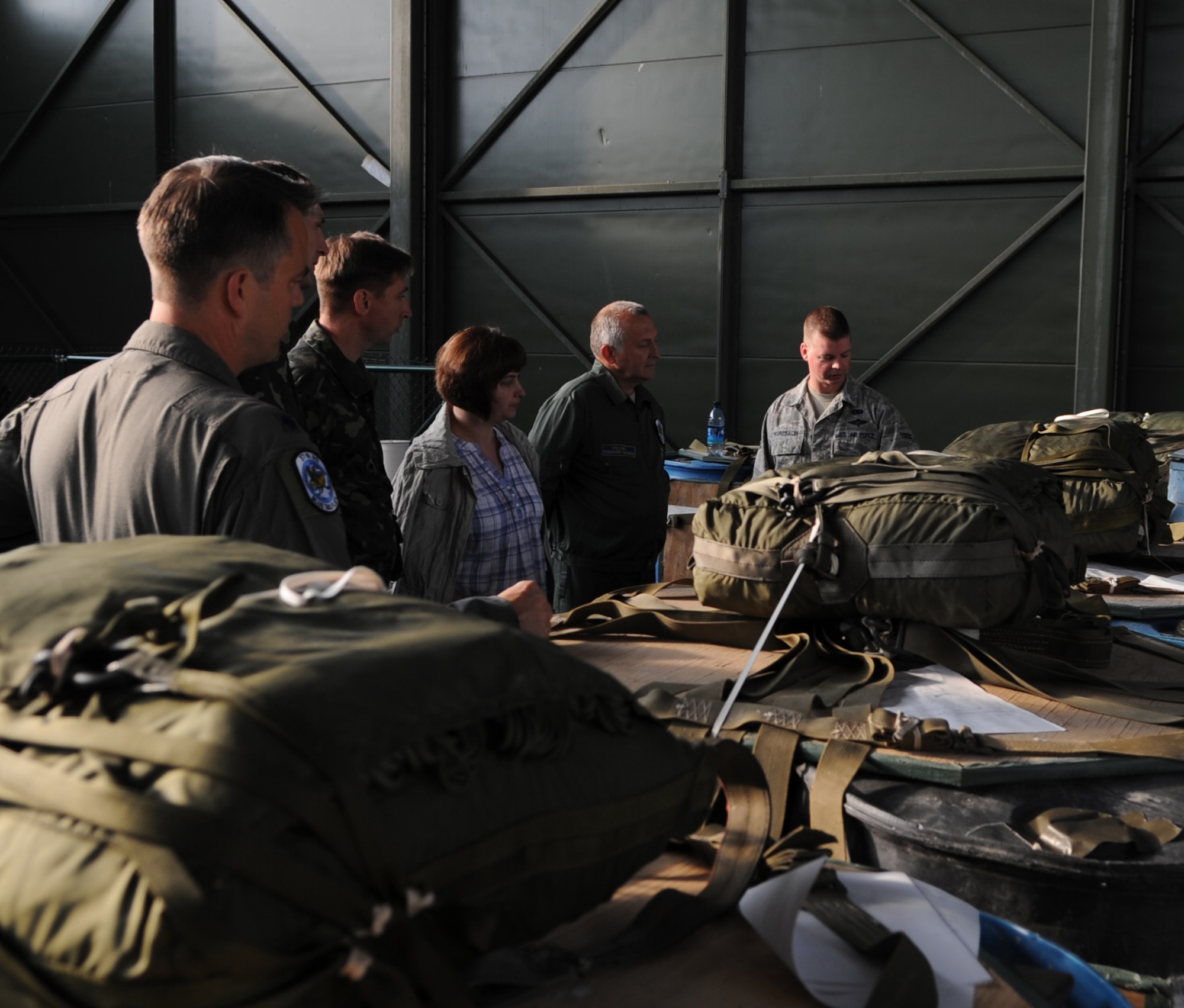U.S. Air Force Airman 1st Class Gregory Wurzbach, 86th Logistics Readiness Squadron aerial delivery, gives a tour of the aerial delivery facility to Ukrainian Air Force members and official interpreter during a visit to Ramstein Air Base, Germany, June 25, 2010. The goal of the Ukrainian visit was to help advance military interoperability and build international partnerships. (U.S. Air Force photo by Senior Airman Caleb Pierce)