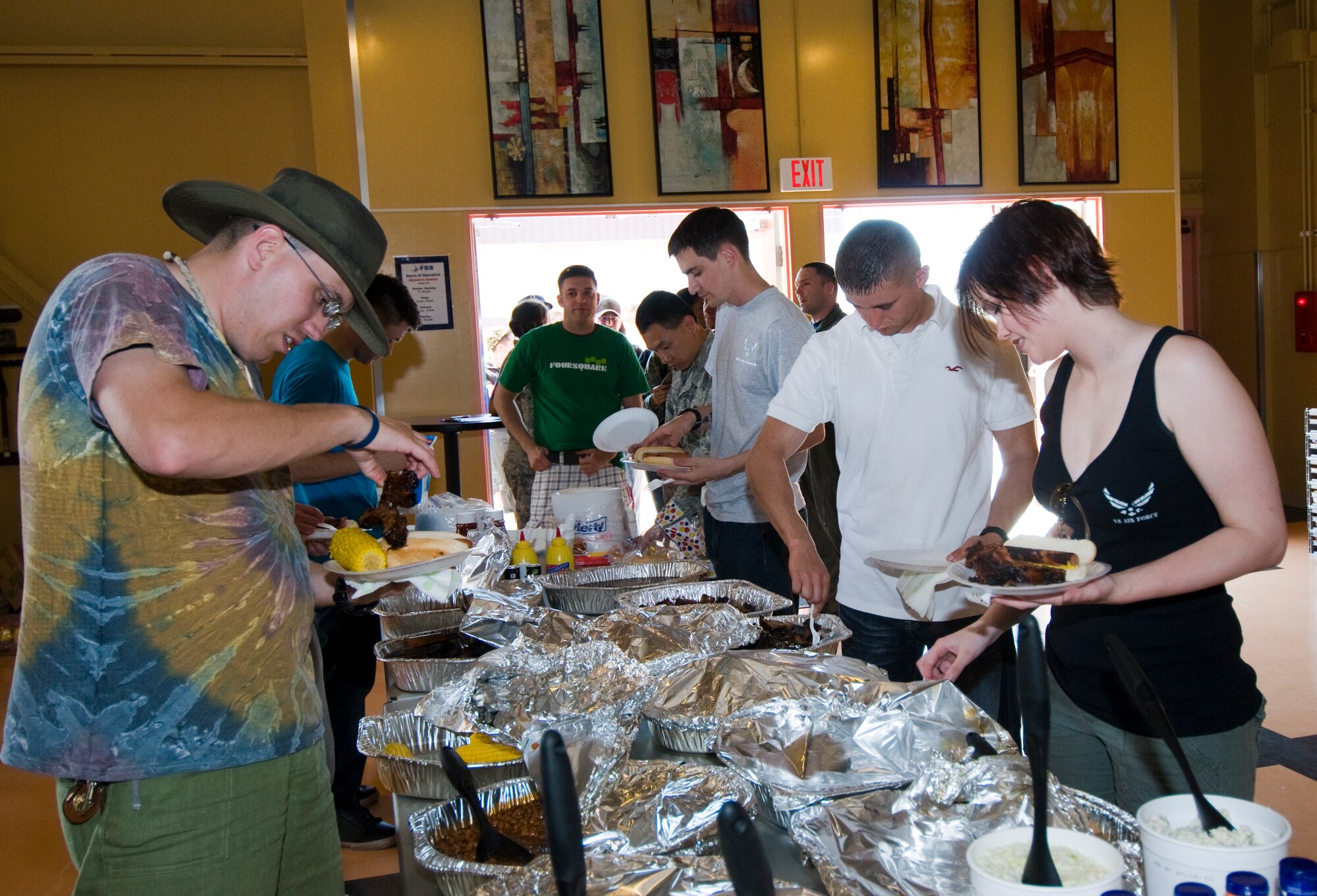 Junior enlisted Airmen enjoy free food, music and games at the Airmen’s Center, June 25, during a summer block party celebration. The event, a Year of the Air Force Family initiative, invited Airmen to the state-of-the-art recreational facility, which offers ranks of airman basic to senior airman a comfortable and exclusive environment to spend time. (U.S. Air Force photo/Senior Jessica Lockoski) 