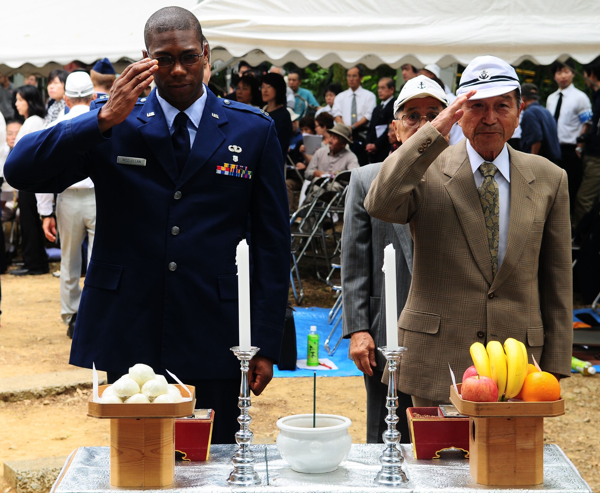SHIZUOKA, Japan -- Capt. Jeffrey McClellan, 374th Medical Group chief of bioenvironmental engineering flight operations, and a World War II Japanese Imperial Navy veteran salute a memorial June 12 during the B-29 Memorial Ceremony. The ceremony was held pay tribute to the lives that were lost during the bombing raid that leveled 66 percent of Shizuoka city. (U.S. Air Force photo/Airman 1st Class Sean Martin)