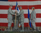 KUNSAN AIR BASE, Republic of Korea -- Col. John Dolan, 8th Fighter Wing commander, presents the guidion to Col. Steven Caberto during the 8th Medical Group Change of Command Ceremony June 25. Colonel Caberto is replacing the former commander Col. Janet Deltuva.    (U.S. Air Force photo/ Senior Airman Roy Lynch)