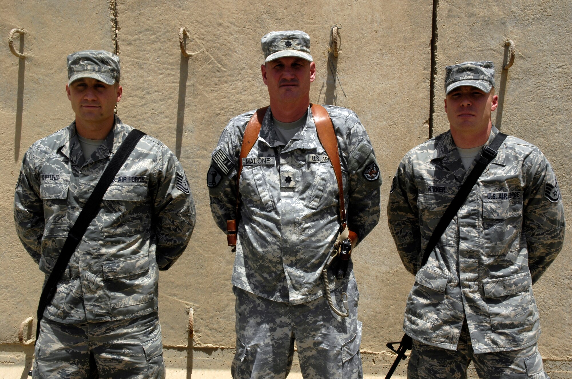 Tech. Sgt. Aaron Gufford (left) and Staff Sgt. Jeffery Kirker (right), both of the 392nd Expeditionary Signal Battalion at Camp Liberty, Iraq, were on their way to the gym June 7,2010, when they saw Lt. Col. Mitchell Malone (center), U.S. Forces-Iraq, having a heart attack. Colonel Malone says the non commissioned officers quick reactions saved his life. (U.S. Air Force photo by Staff Sgt. Sanjay Allen/Released)