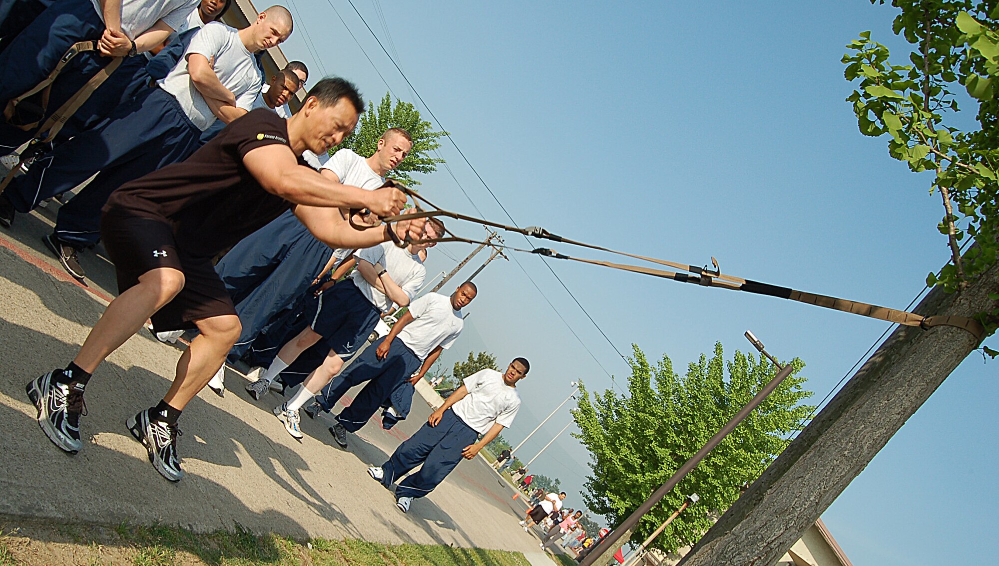 KUNSAN AIR BASE, Republic of Korea -- Benny Miguel, 8th Force Support Squadron fitness center director, shows Airmen how to use the Total Resistance Exercise system. TRX is a mobile fitness system that uses a suspense harness and your own body weight to workout.  (U.S. Air Force photo/Senior Airman Roy Lynch)