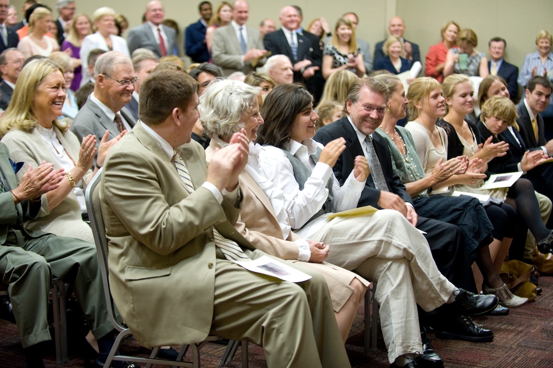 Friends and family members of former Defense Secretary Donald H. Rumsfeld applaud his wife Joyce for her support during Rumsfeld's portrait unveiling ceremony at the Pentagon, June 25, 2010.