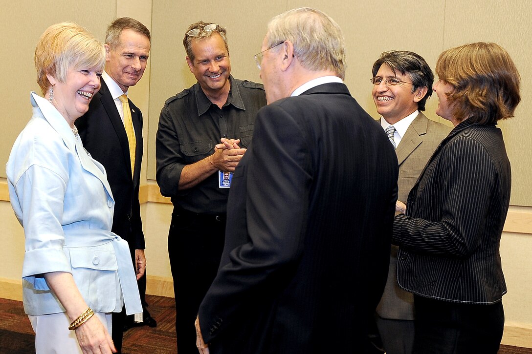 Former Defense Secretary Donald H. Rumsfeld speaks with former Chairman of the Joint Chiefs of Staff Gen. Peter Pace and his wife Lynne, left, former Pentagon press correspondent Jamie Mcintyre, center, and his daughter and son-in-law, right, following his portrait unveiling ceremony at the Pentagon, June 25, 2010.