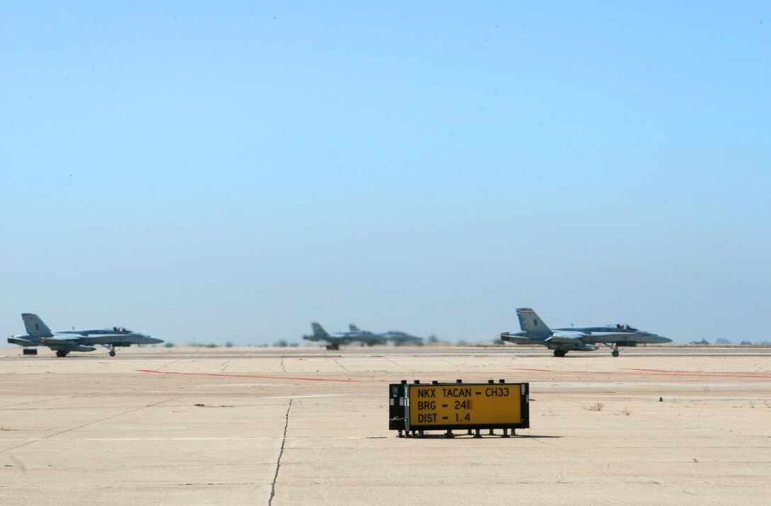 F/A-18 "Hornets" line up on the runway in preparation for take off from Marine Corps Air Station Miramar's flight line June 25. More than 20 aircraft from MCAS Yuma, Ariz., Mountain Home Air Force Base, Idaho and Nellis AFB, Nev., participated in the Marine Division Tactics Course and exercise Trident Warrior here.