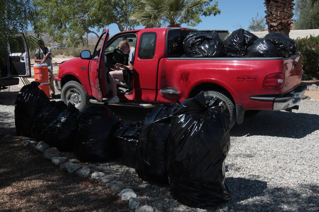The Marines bagged about 25 bags worth of weeds in four hours while helping two local women clean their yard Saturday morning.