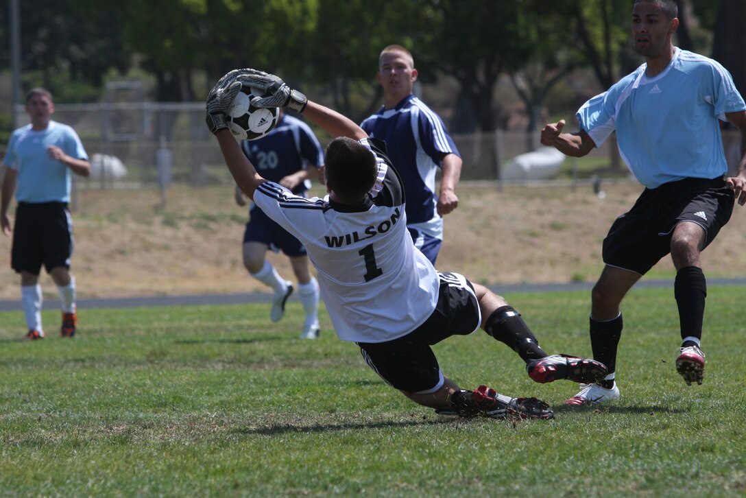 AJ Wilson, the goalkeeper for the Combat Center's installation soccer team, saves the ball as it is kicked toward the goal during a tournament game against the Marine Corps Air Station Miramar installation soccer team June 26 at the Marine Corps Base Camp Pendleton.