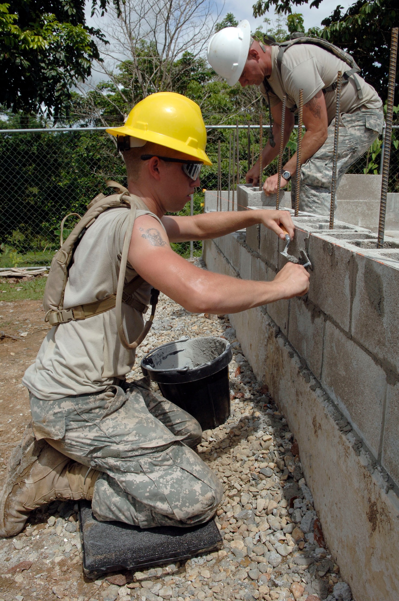 Spc. Kevin Schaeffer (left) and Sgt. Richard Fischer, construction engineers with the 372nd Engineer Company, mortar the first bricks into place June 26 at Santa Librada elementary school in Panama. The Army Reservists are deployed in support of New Horizons Panama 2010, a humanitarian assistance mission designed to strengthen partnerships between the United States and Panama. (U.S. Air Force photo/Tech. Sgt. Eric Petosky)