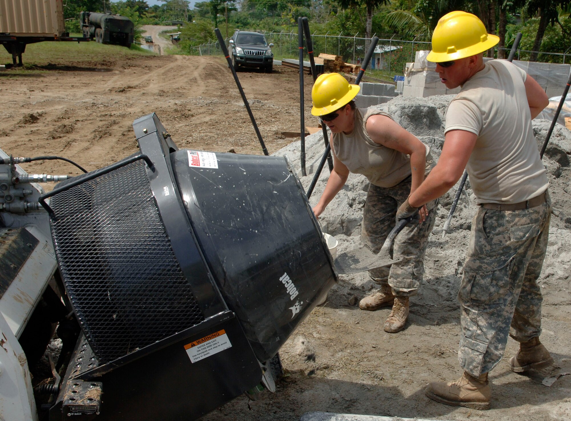 Spc. Jennifer Bartlein (left) and Pfc. Wayne Paliwoda, construction engineers with the 372nd Engineer Company, mix concrete June 26 at Santa Librada elementary school in Panama. The Army Reservists are deployed in support of New Horizons Panama 2010, a humanitarian assistance mission designed to strengthen partnerships between the United States and Panama. (U.S. Air Force photo/Tech. Sgt. Eric Petosky)