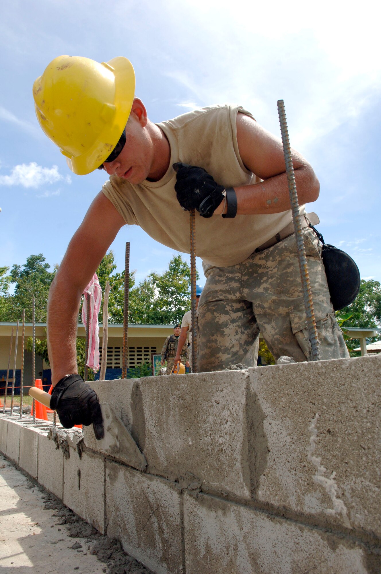 Spc. Michael Wiken, construction engineer with the 372nd Engineer Company, uses mortar on the first layer of bricks June 26 at Santa Librada elementary school in Panama. The Army Reservists are deployed in support of New Horizons Panama 2010, a humanitarian assistance mission designed to strengthen partnerships between the United States and Panama. (U.S. Air Force photo/Tech. Sgt. Eric Petosky)